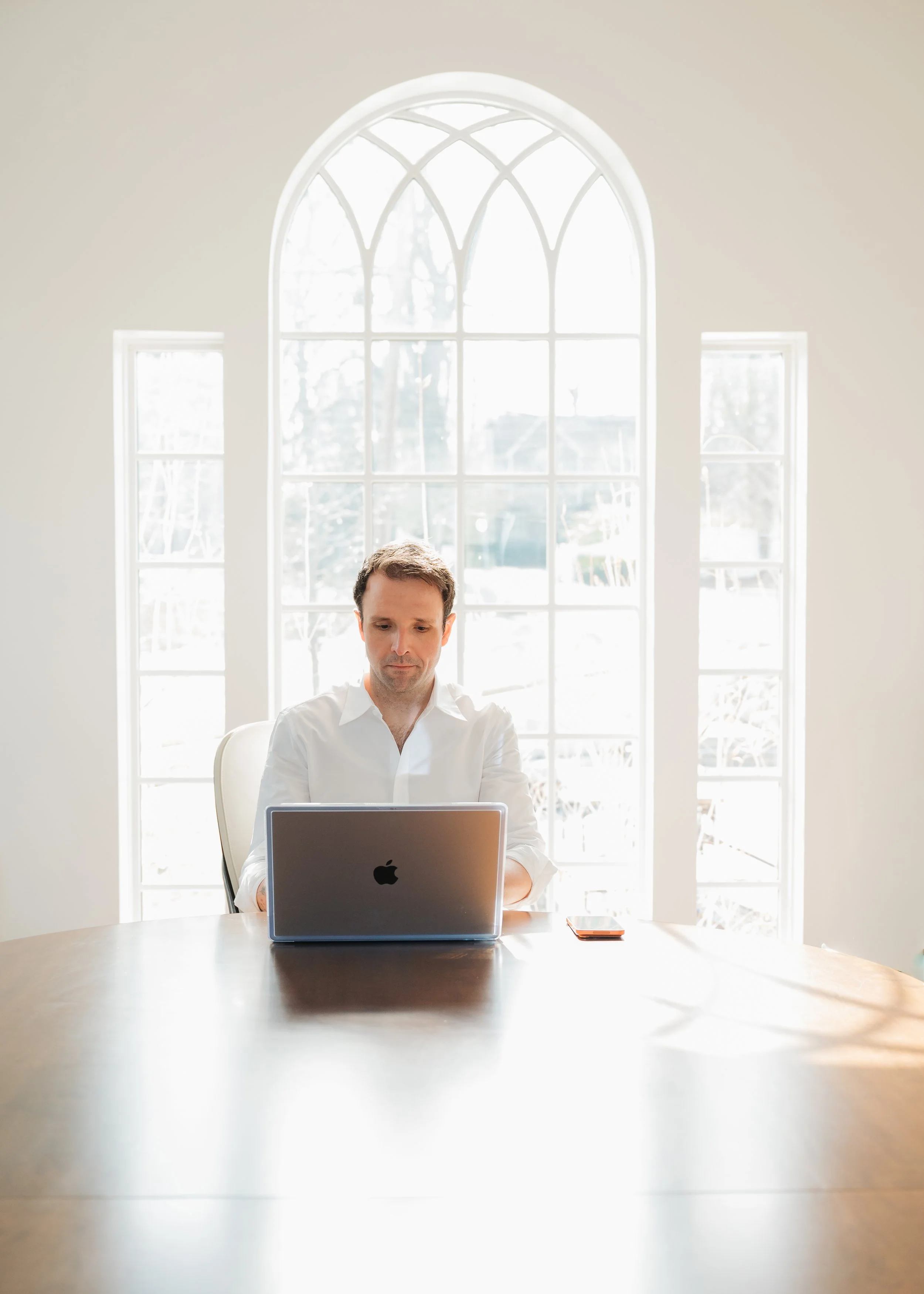 A portrait of a general counsel working on his computer