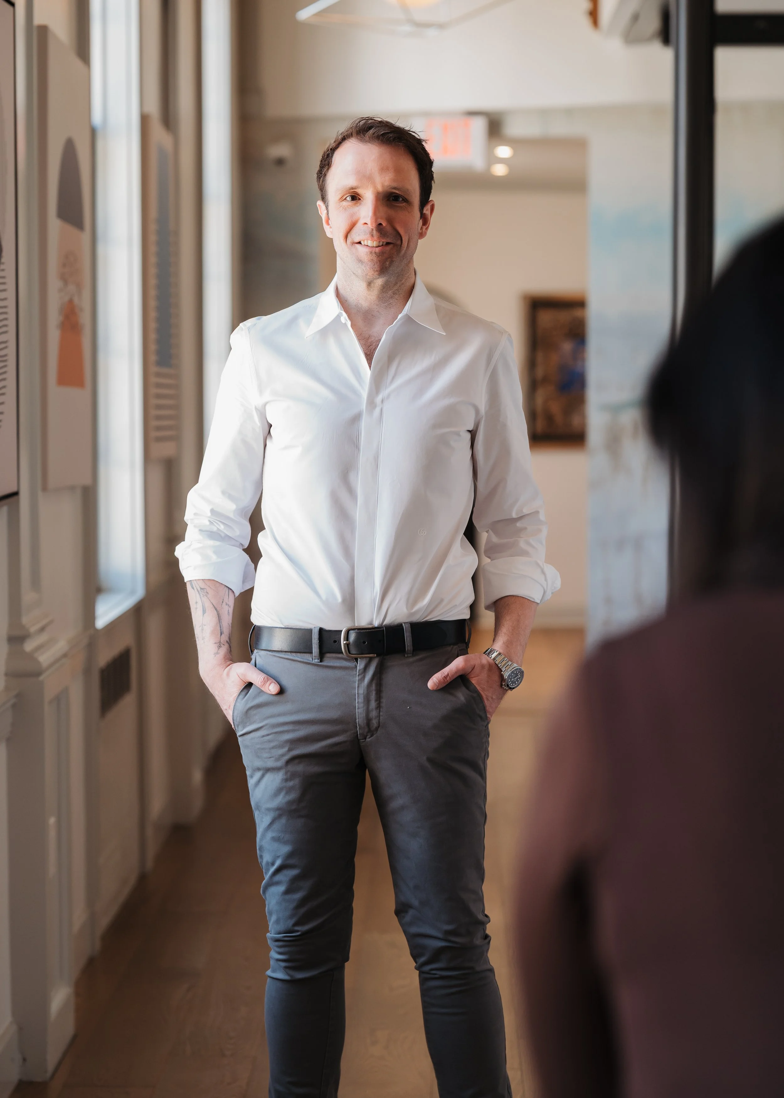 A relaxed personal brand portrait of an executive vice president and general counsel in an office space.