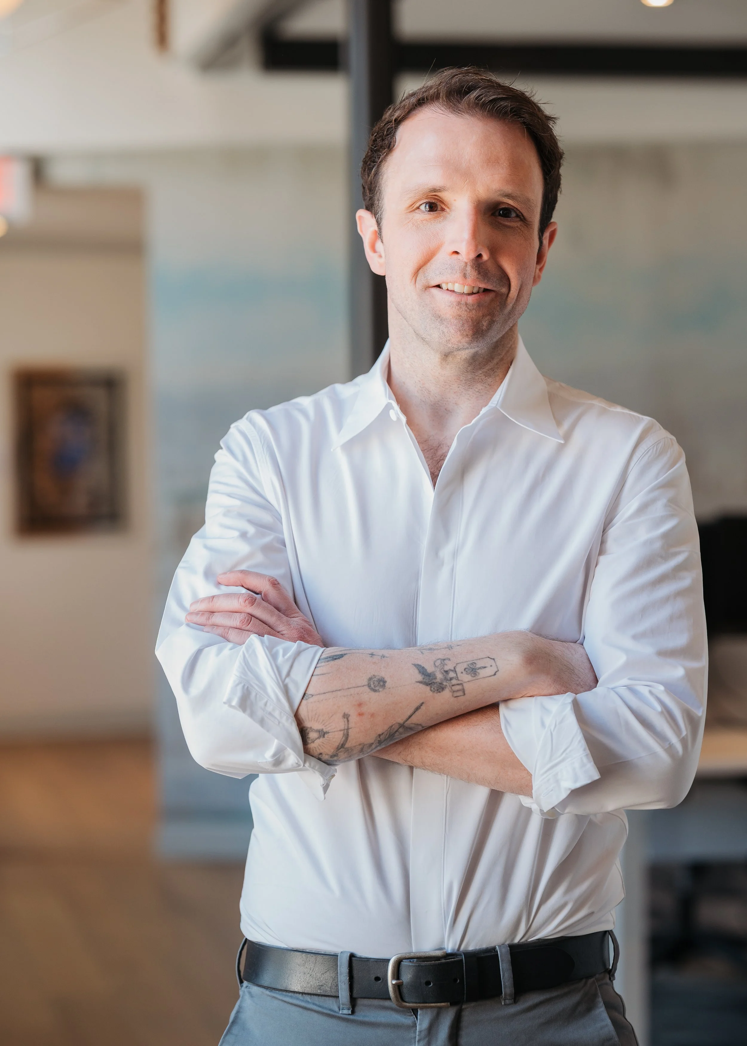 A personal branding headshot of an executive in an office space