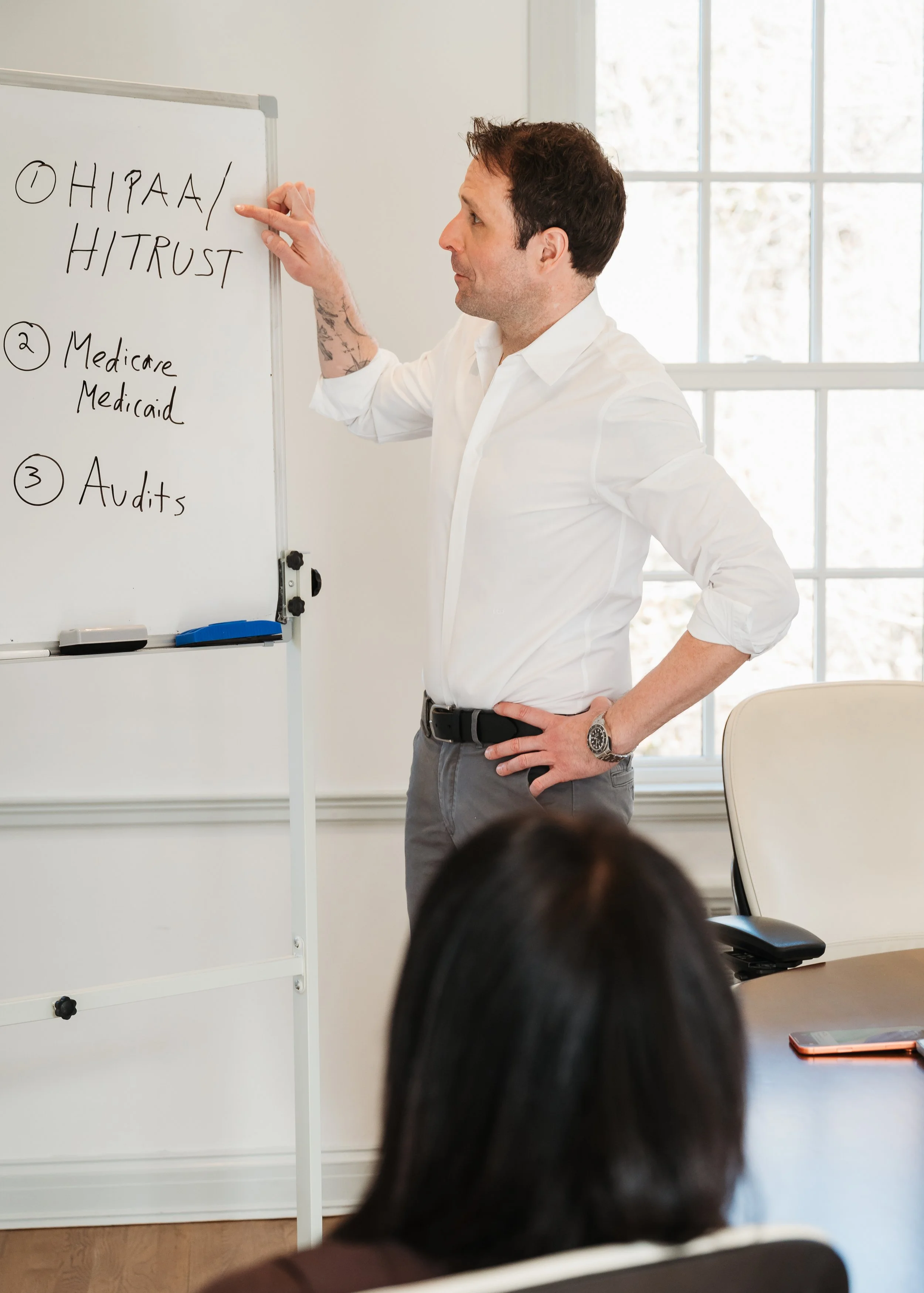 An action branding shot of a general counsel during a meeting with a client