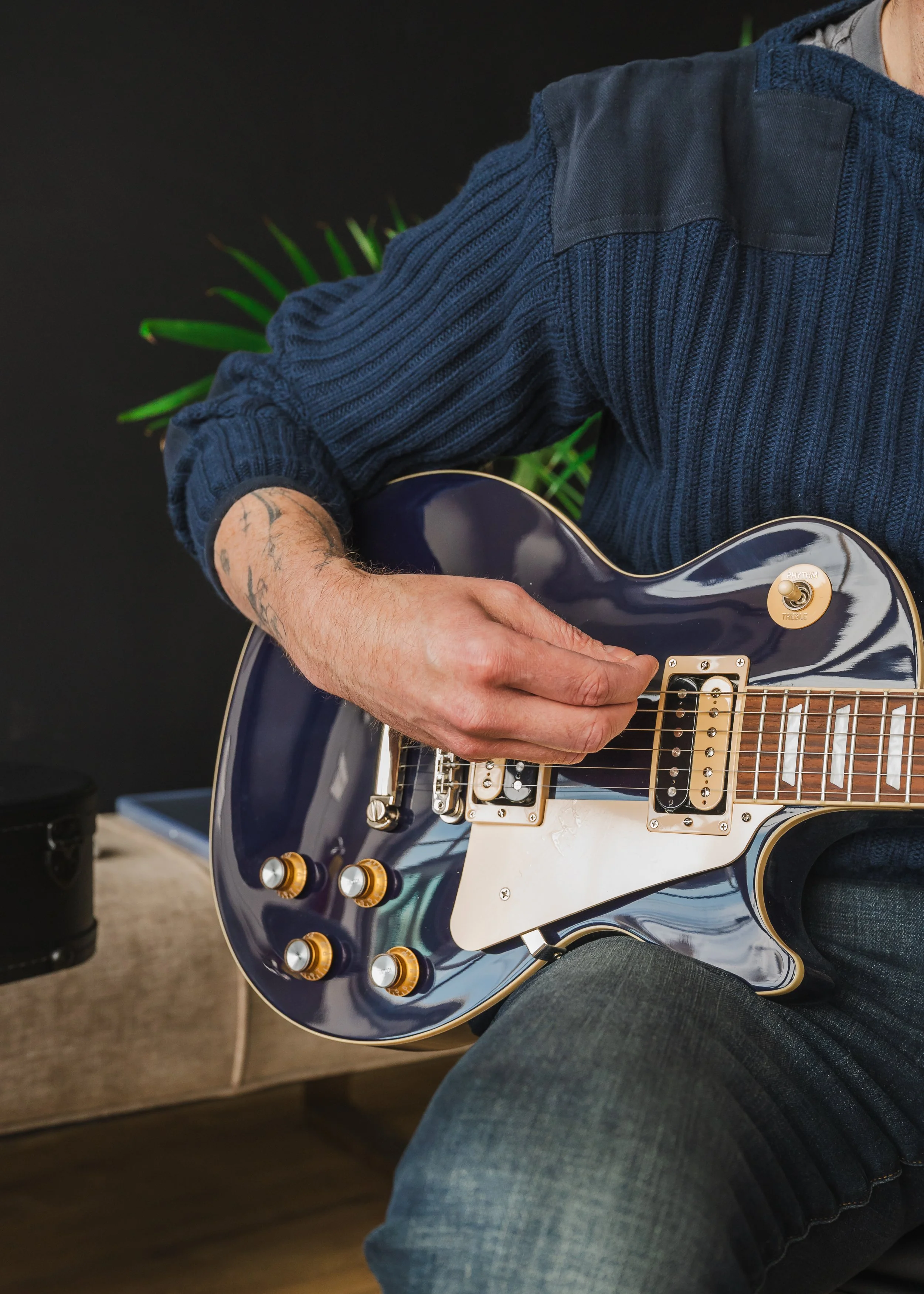 A branding shot of a general counsel taking a moment to relax playing his guitar