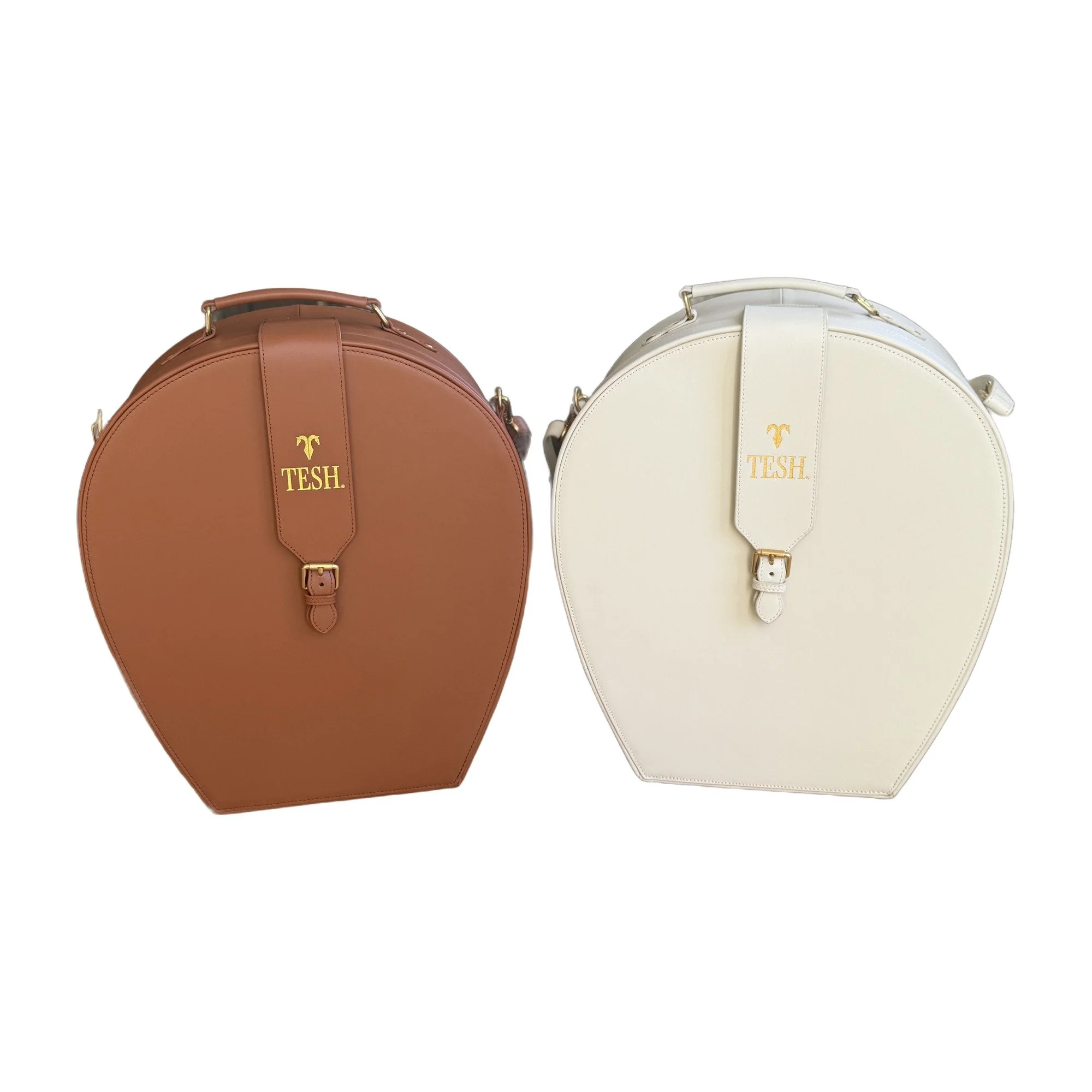 TESH® leather hat carriers in chestnut and ivory, travel hat boxes with brass hardware, by TESH® Palm Beach.