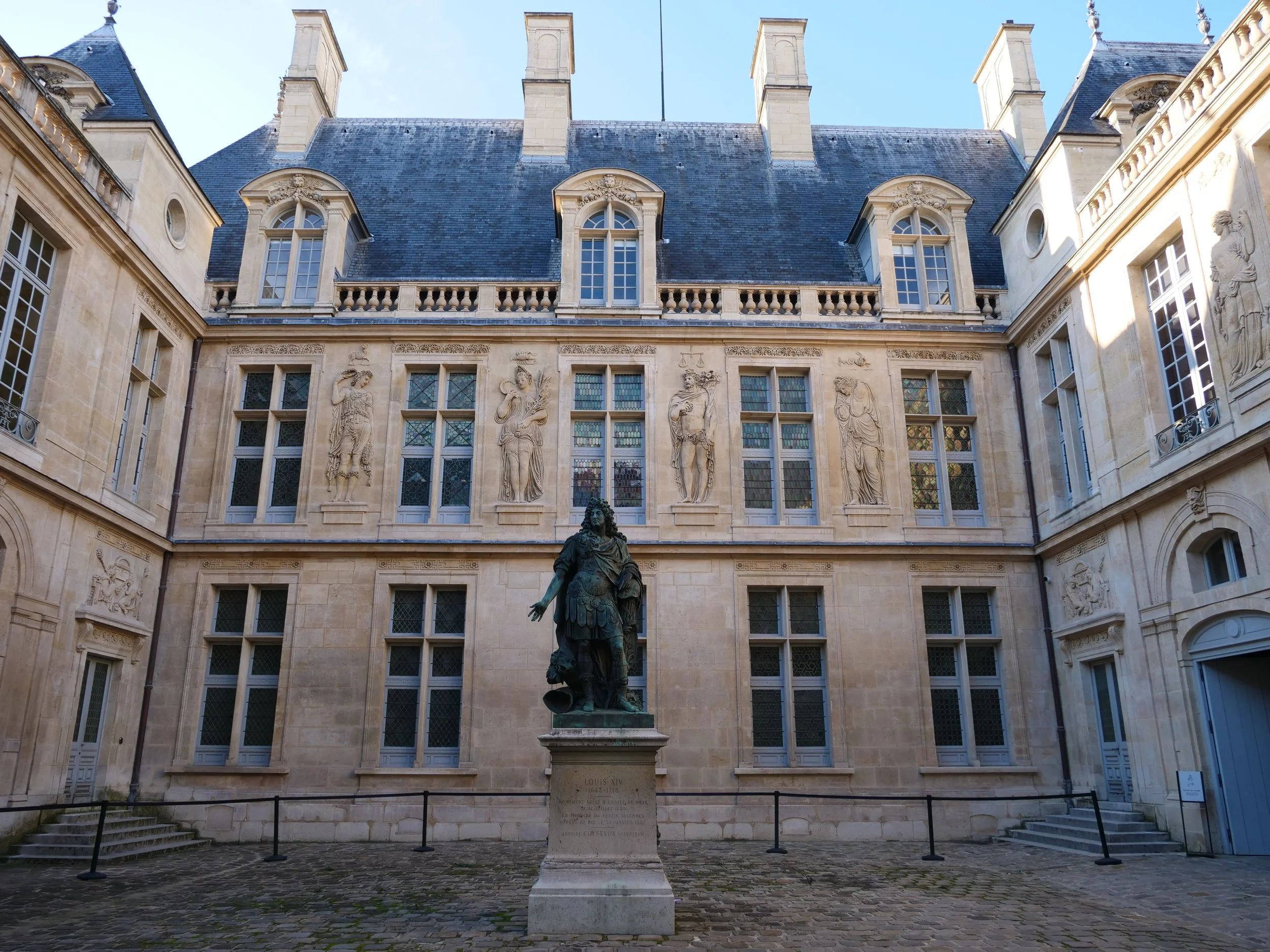 Gaze upon the majestic statue of Louis XIV, a tribute to the Sun King, as you explore the Marais.