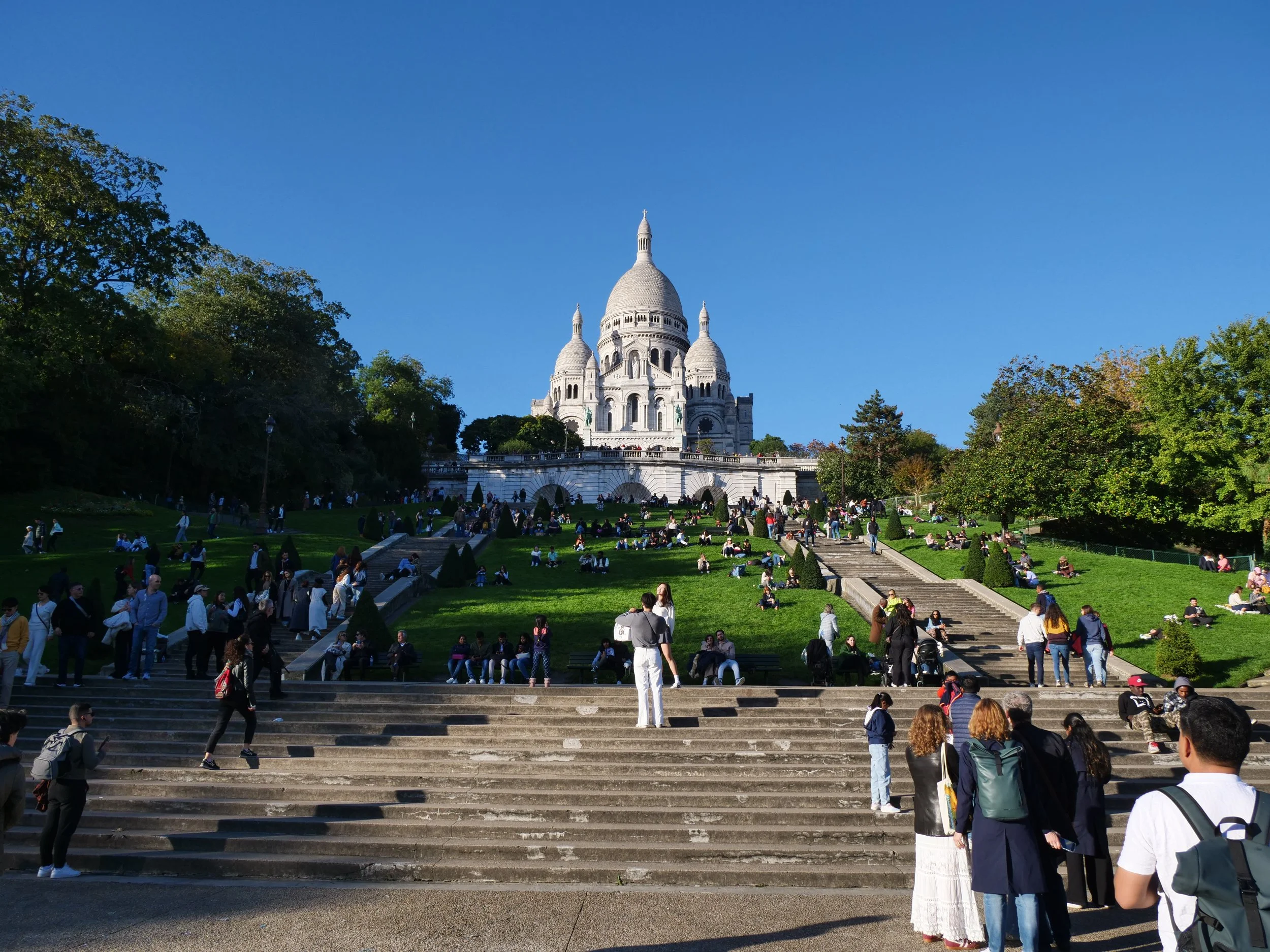 Stroll through the lush Square Louise Michel, a peaceful haven beneath the grandeur of Sacré-Cœur.