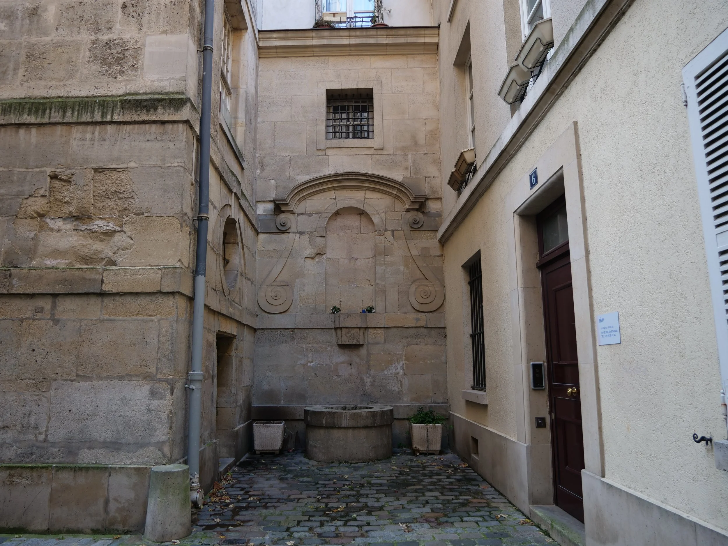 Pause by the Fontaine de la Soeur, a quaint feature that reflects the charm and tranquility of the Marais