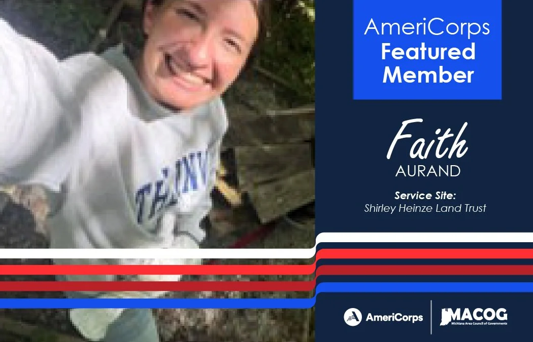 Faith is taking a selfie, smiling at the camera raised above her head.