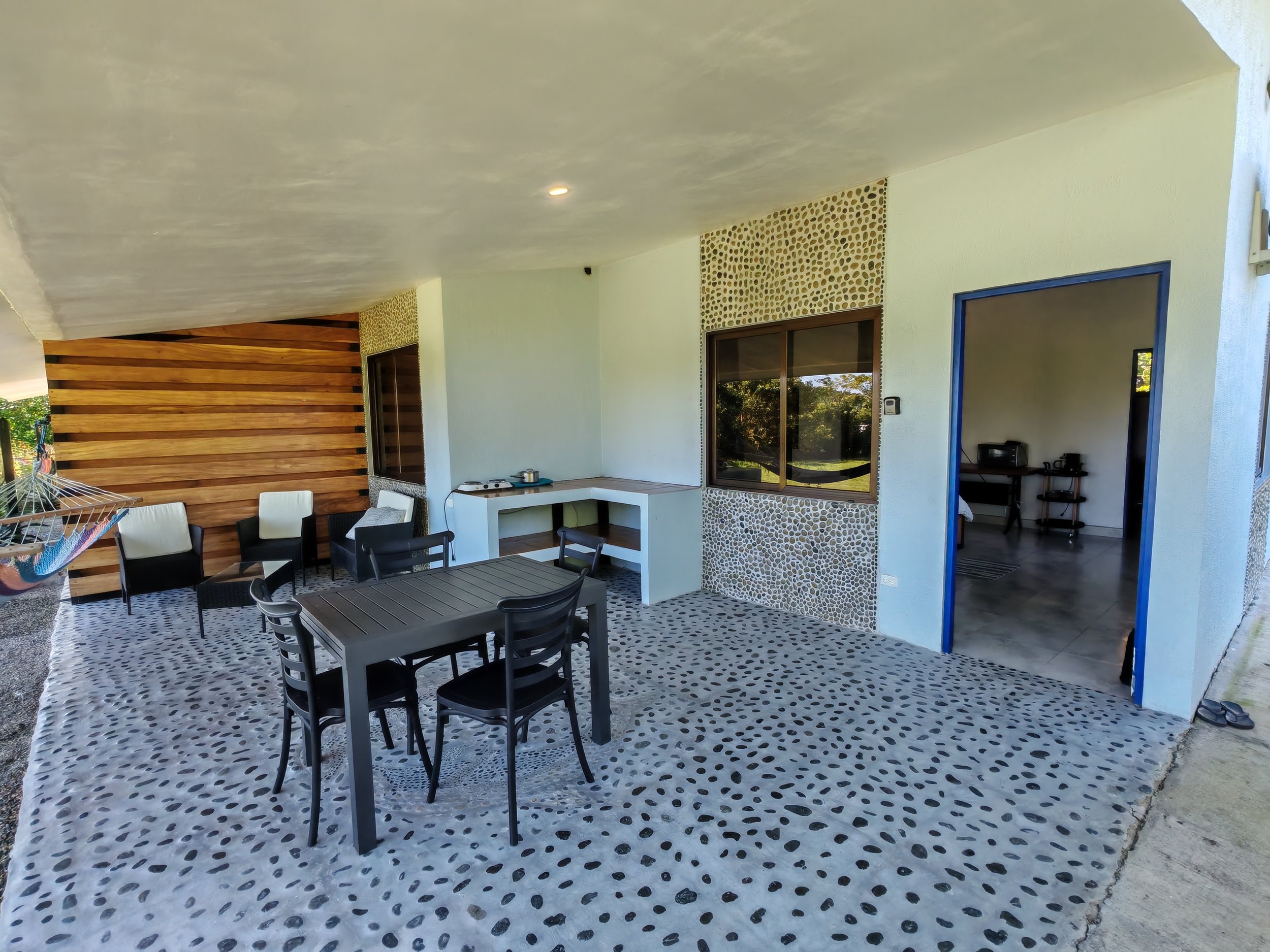 Outdoor terrace with dining table, simple cooking facilities and chill area