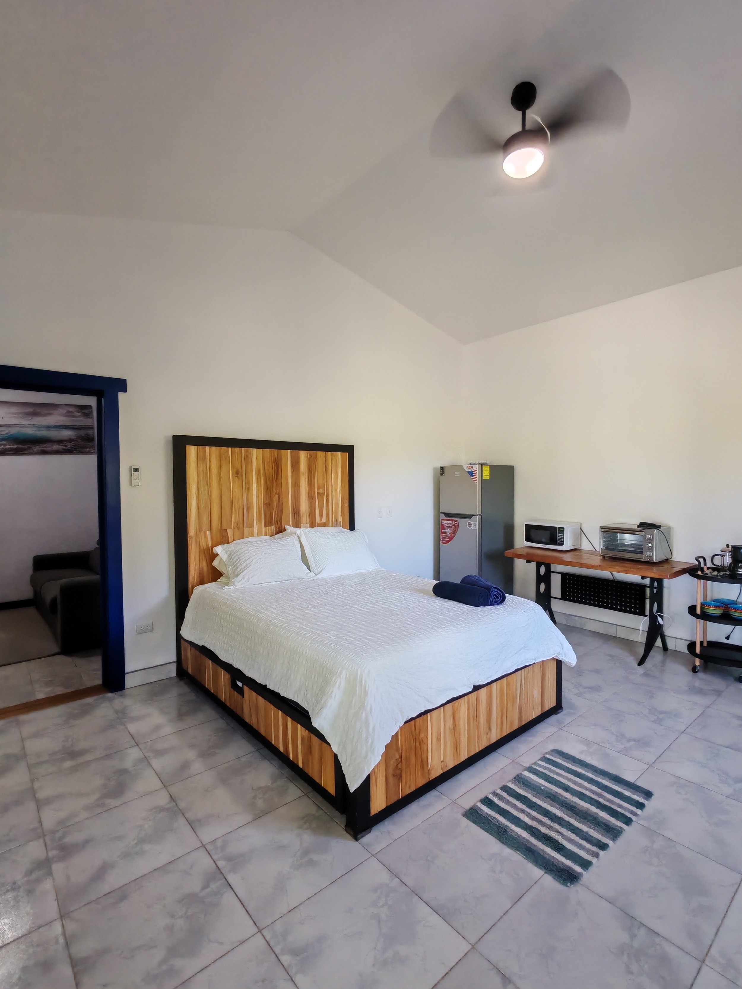 bed, fridge, toaster oven microwave, basic utensils