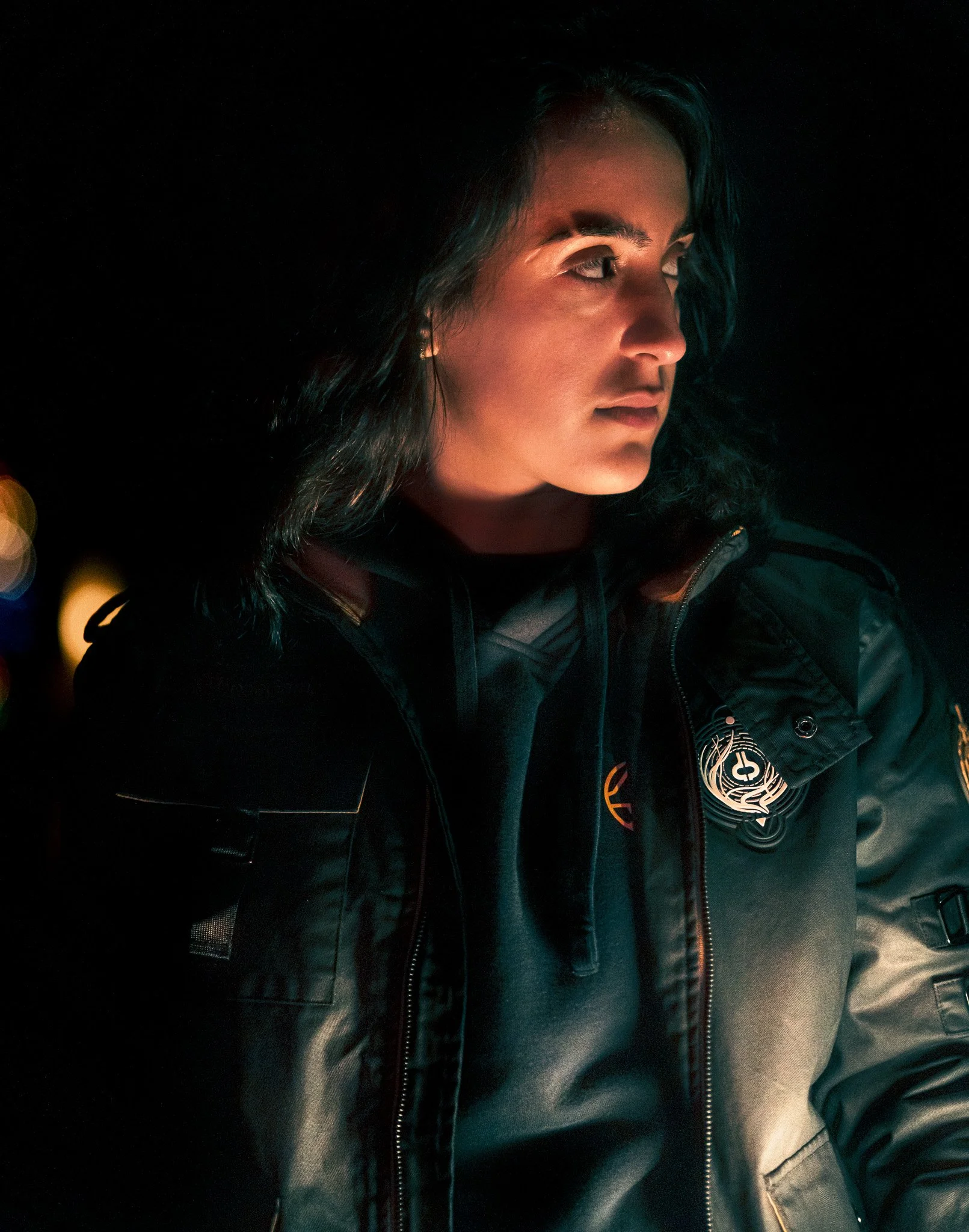 Person wearing a jacket in dim lighting