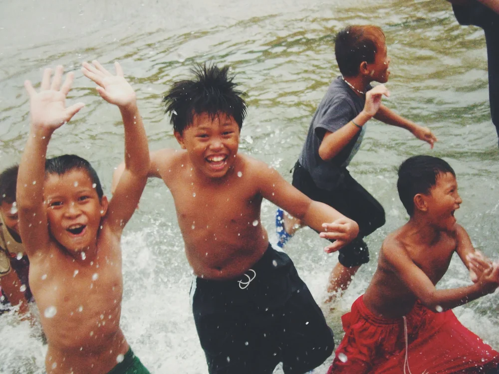 Kids In Flooded Street Manilla | Artist M. Walker's photography