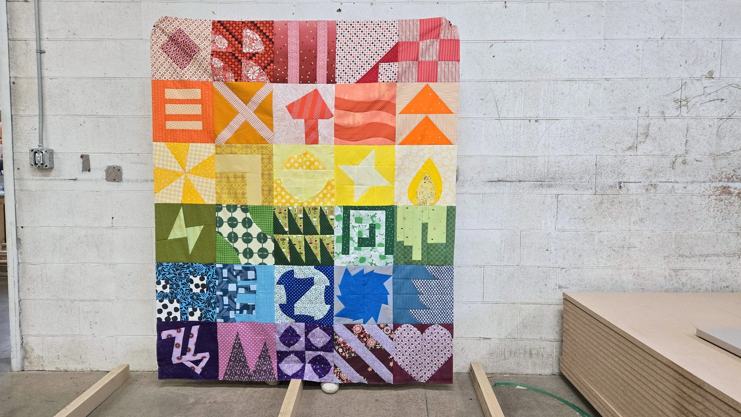 Rainbow themed quilt top with 30 unique improvised quilt blocks