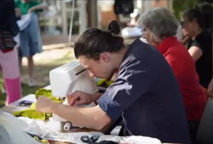 Man sewing at The Great Fashion Stitch-up at Bellingen Show