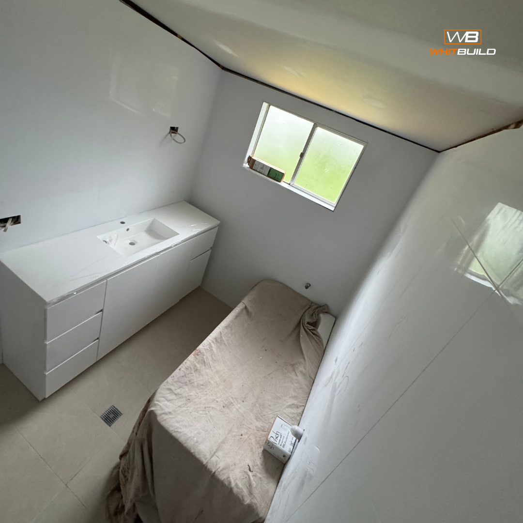 A bathroom under construction with a white vanity sink