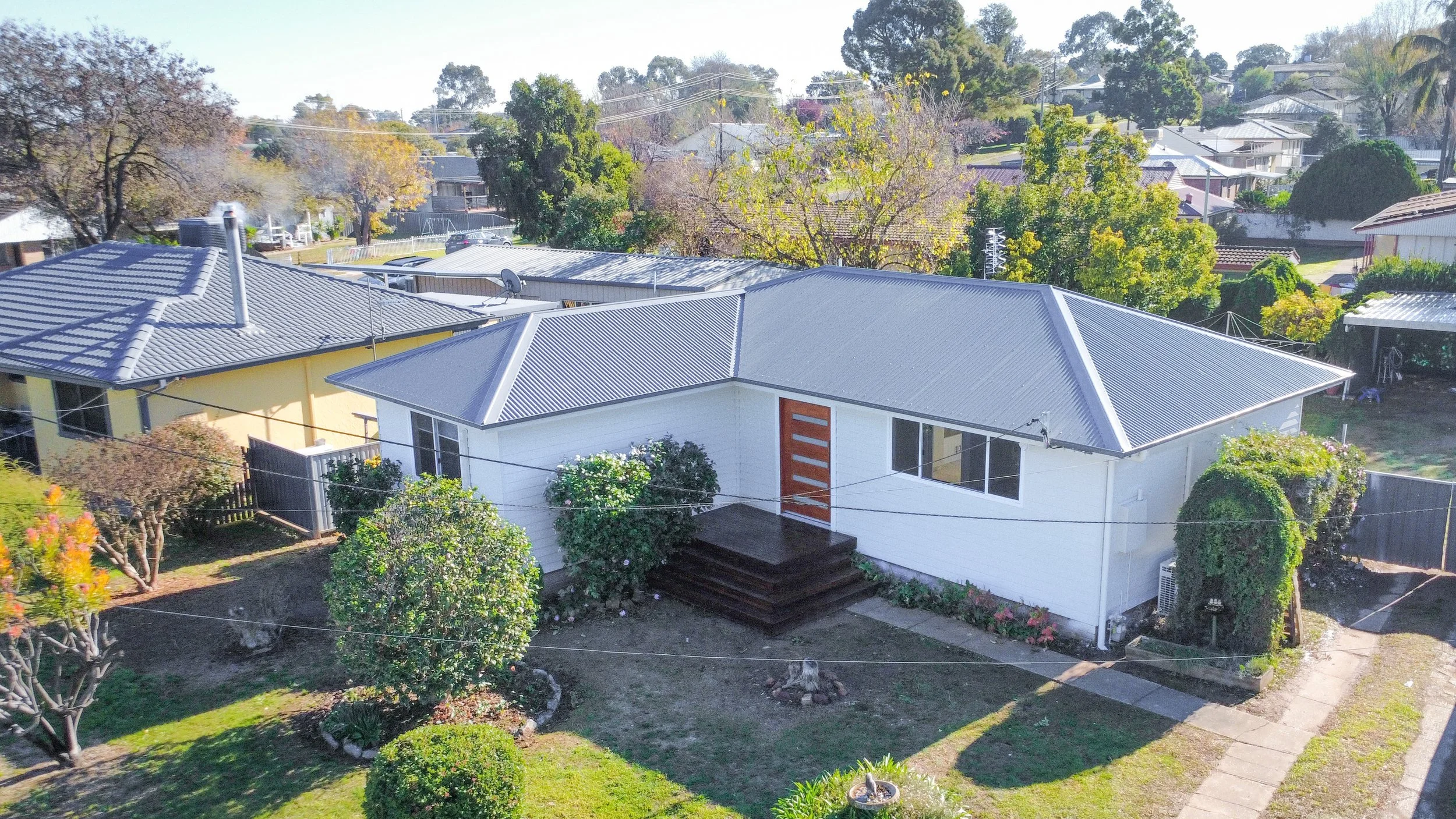 An exterior part of a newly renovated home, with a new metal roof replacement.  This is a full house renovation by Whitbuild, Cowra NSW