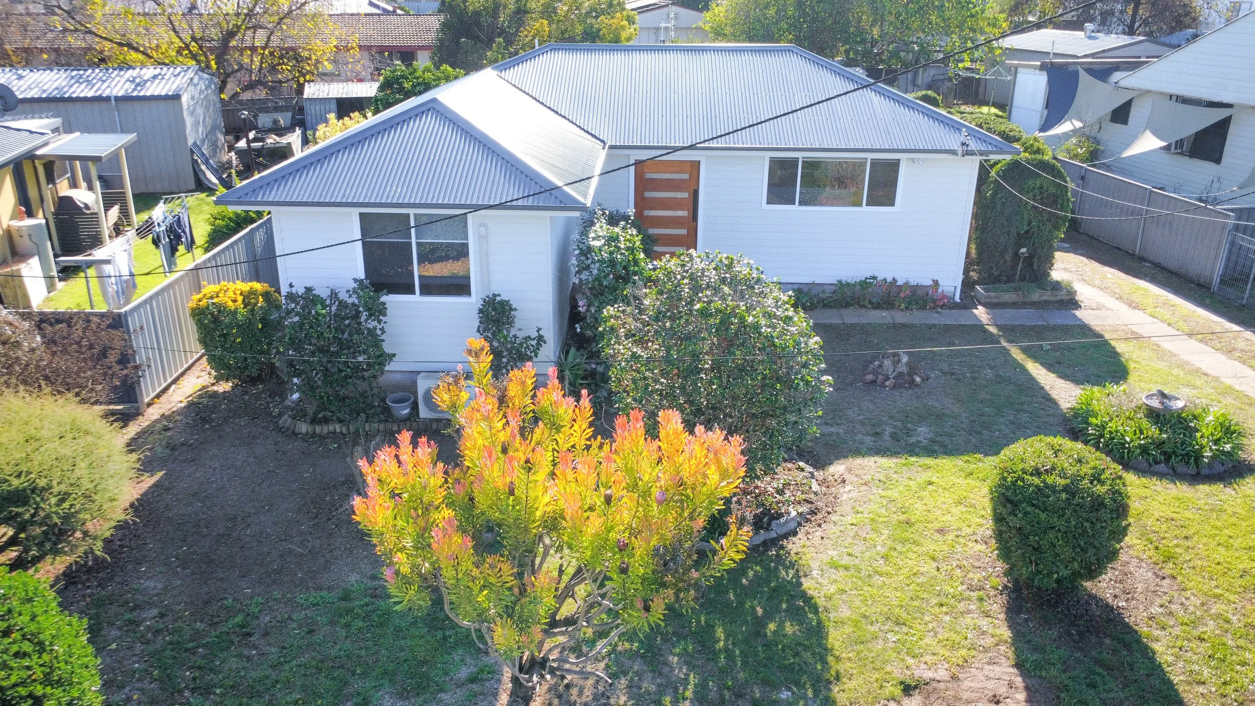 An exterior part of a newly renovated home, with a new metal roof replacement.  This is a full house renovation by Whitbuild, Cowra NSW