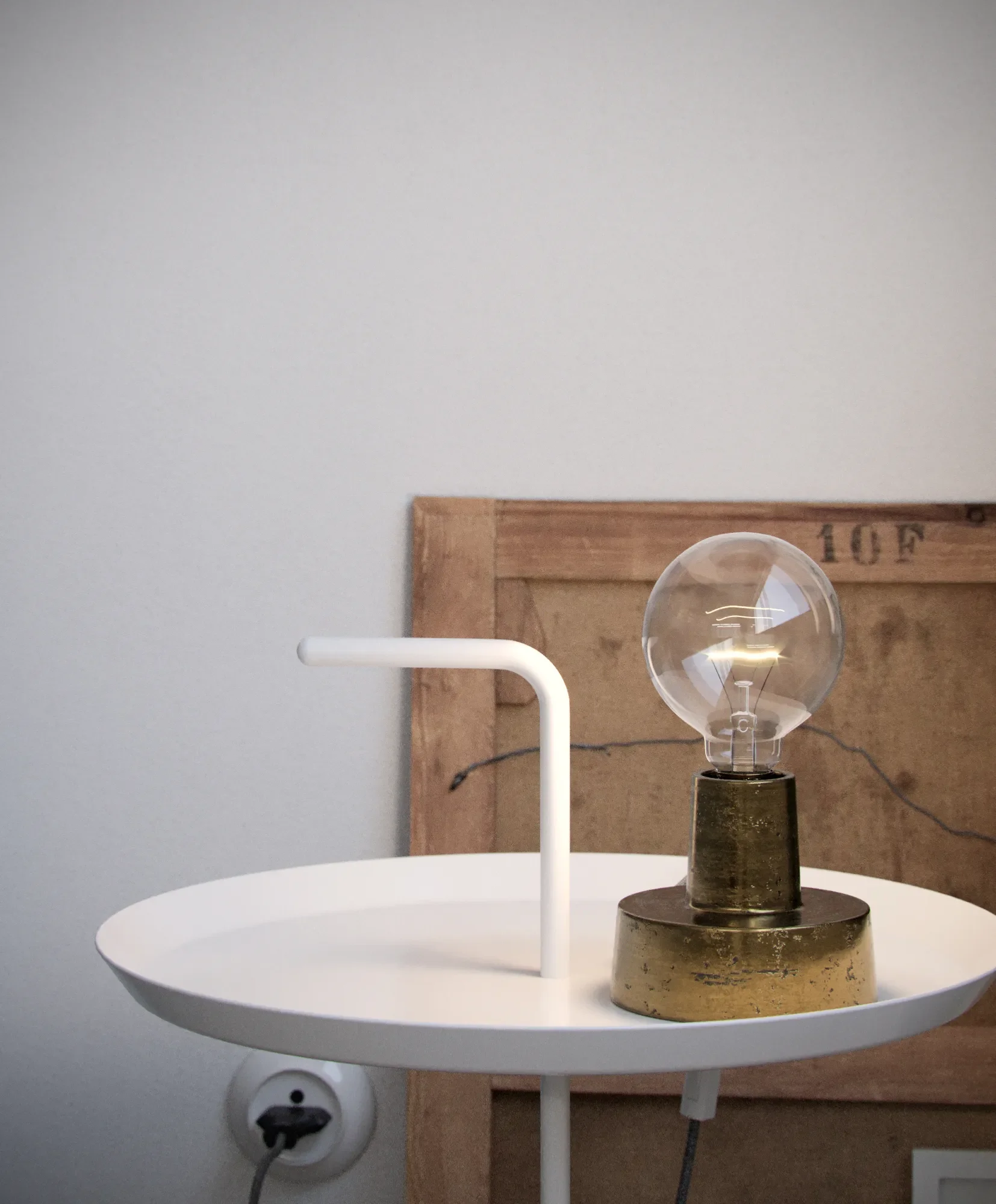 A modern white side table with a white L-shaped handle, a vintage-style light bulb on a brass base, and a wooden board leaning against a white wall.