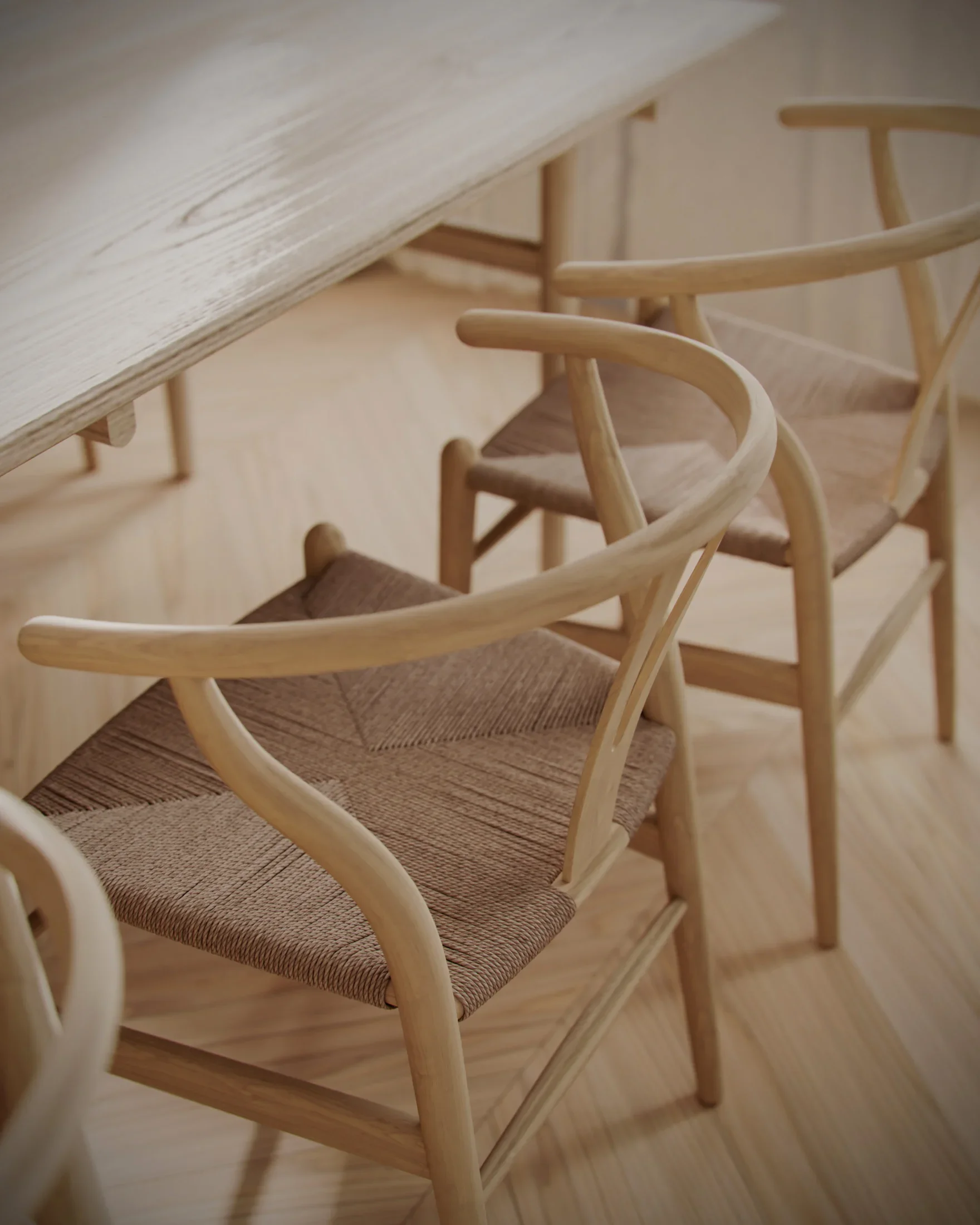Wooden chairs with woven seats arranged around a wooden table.