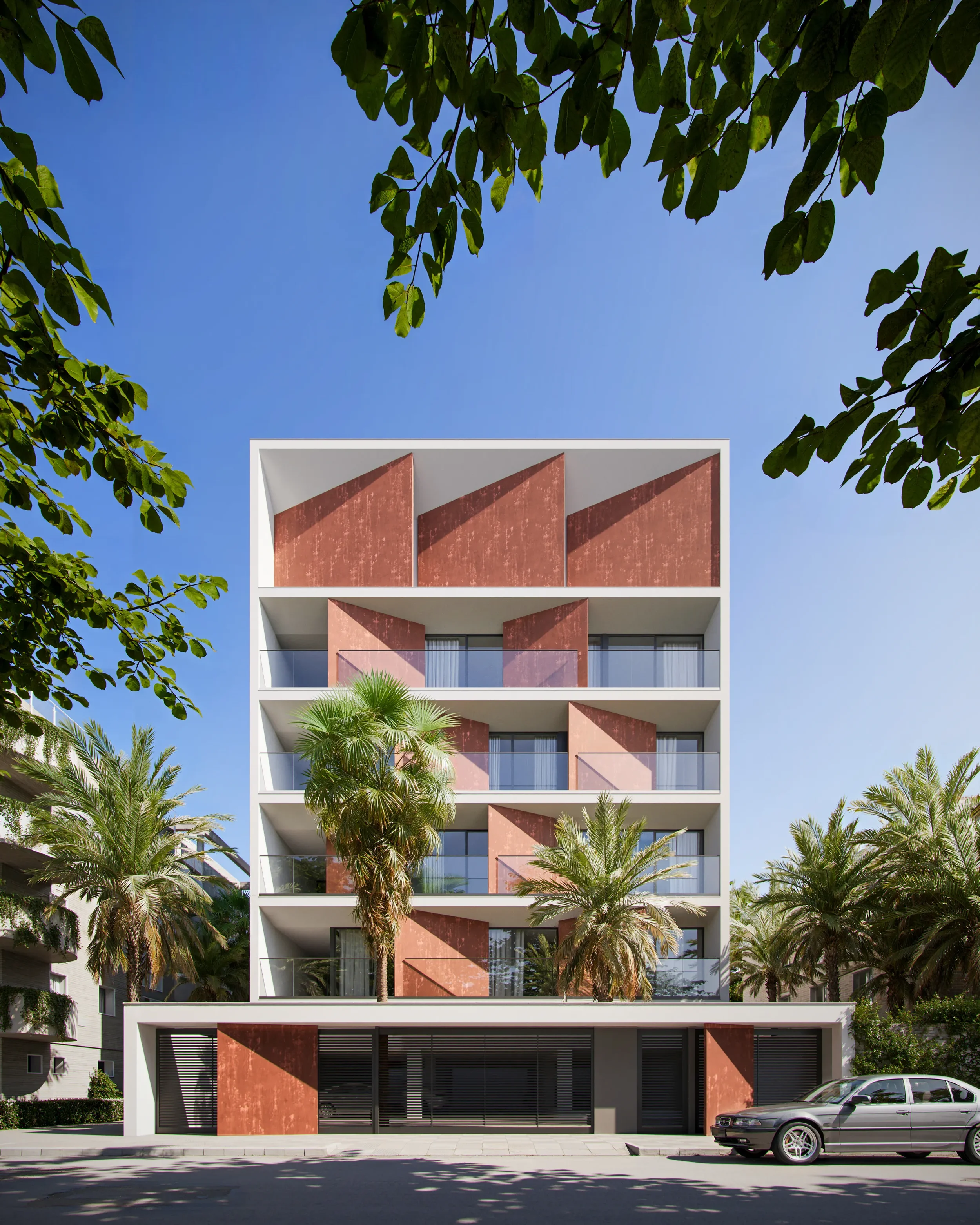 Modern multi-story residential building with a white and terracotta facade, balconies with glass railings, surrounded by palm trees, under a clear blue sky.