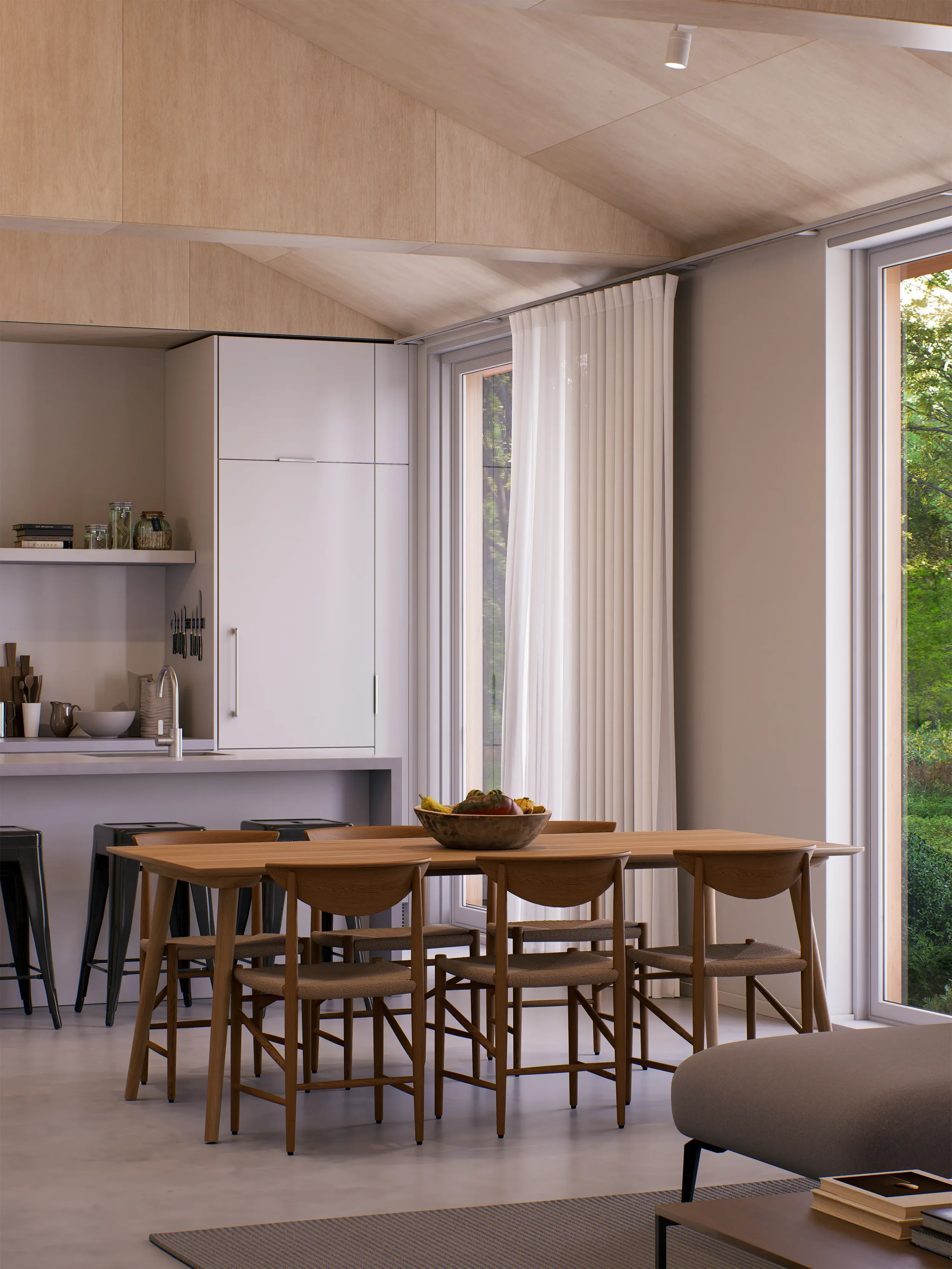 Modern dining area with wooden table and chairs, large glass sliding doors with white curtains, and view of greenery outside.