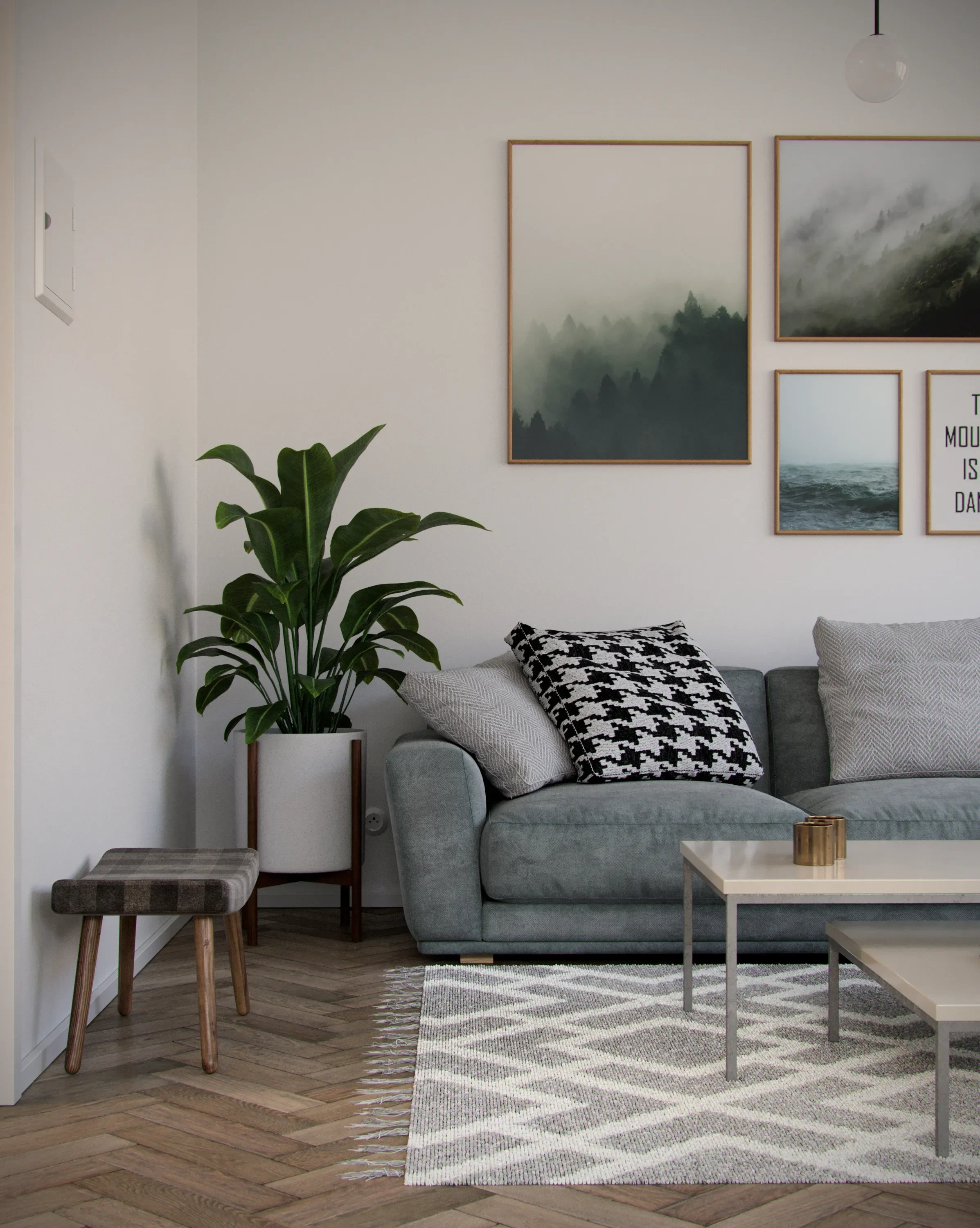 A modern living room with a grey sofa, patterned cushions, a potted plant, framed nature art on the white wall, a rug, and a small coffee table.