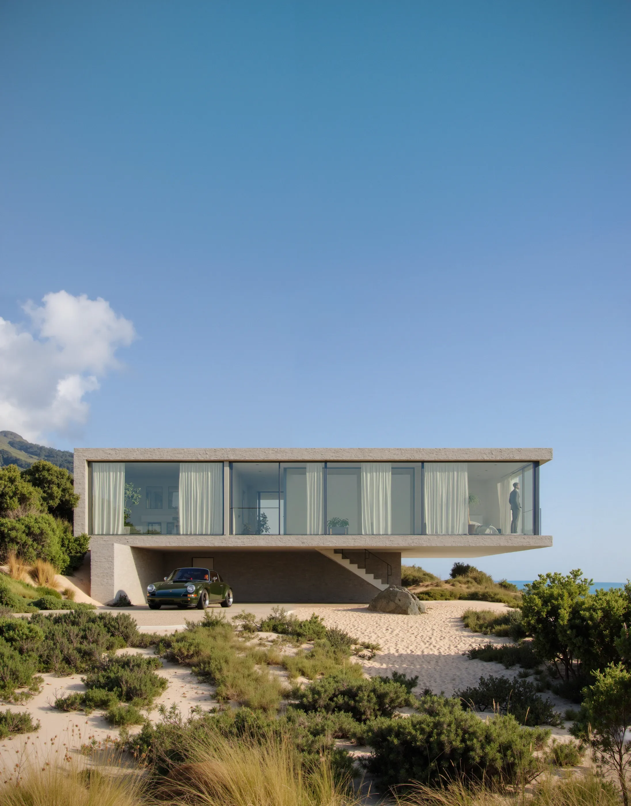 Modern house with glass walls on stilts, a black sports car parked underneath, surrounded by sandy terrain and greenery, with a mountain and blue sky in the background.