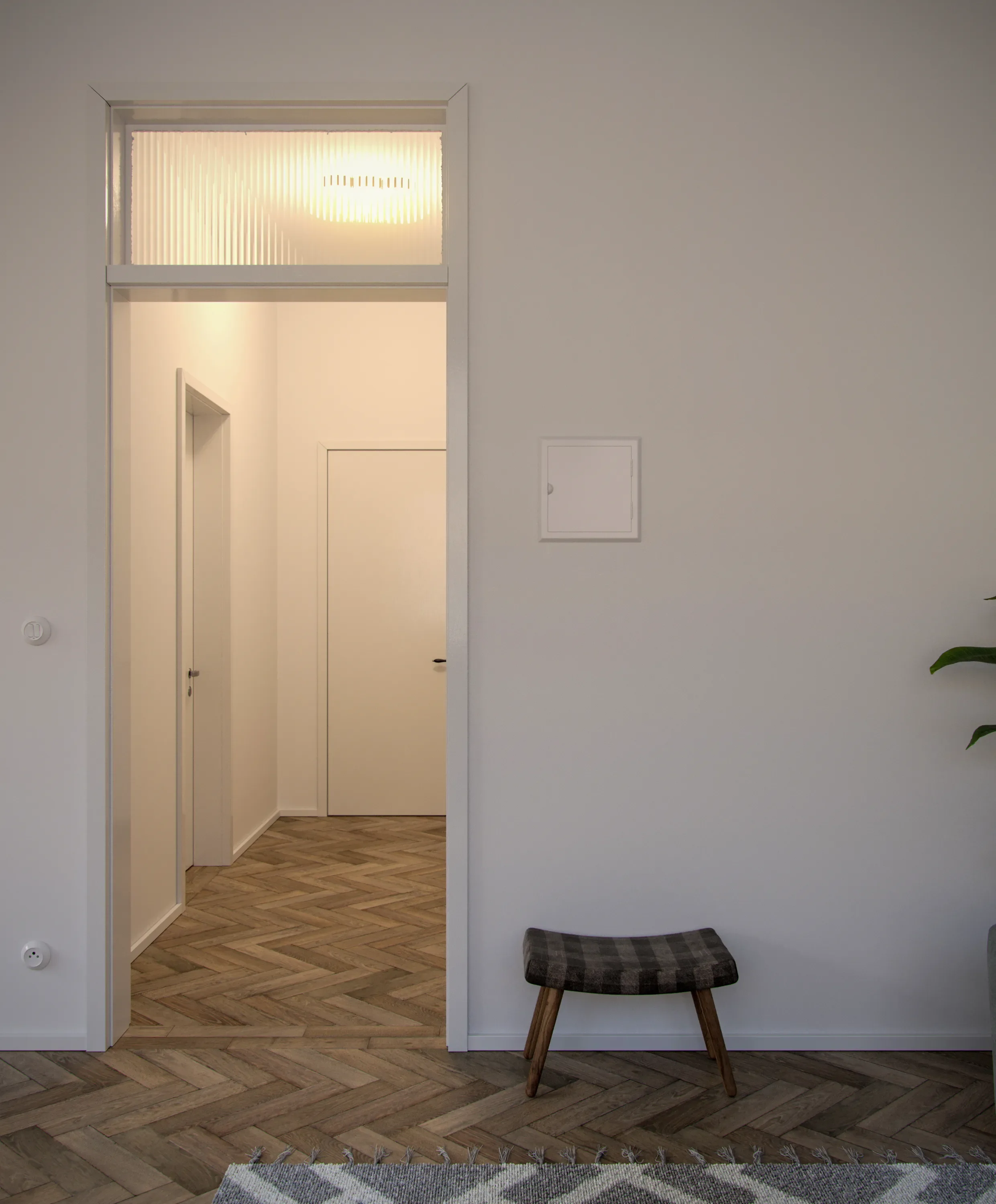 Interior view of a room with white walls, a small plaid upholstered bench with wooden legs, a gray and white patterned rug, and a partial view of a potted plant. A doorway with a textured glass transom above leads to a hallway with wooden herringbone