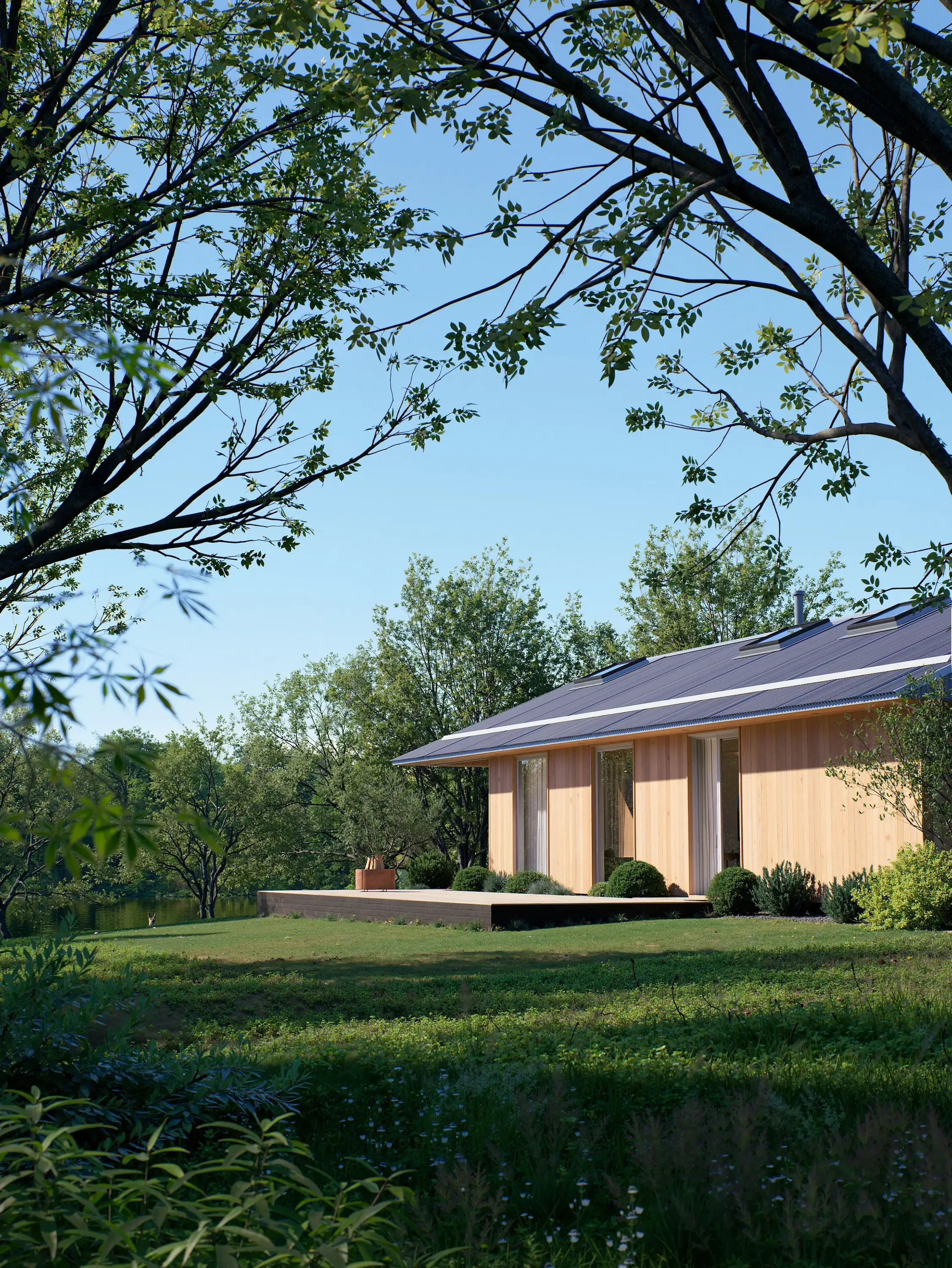A modern house with a wooden exterior, large windows, and solar panels on the roof, surrounded by greenery and trees under a clear blue sky.