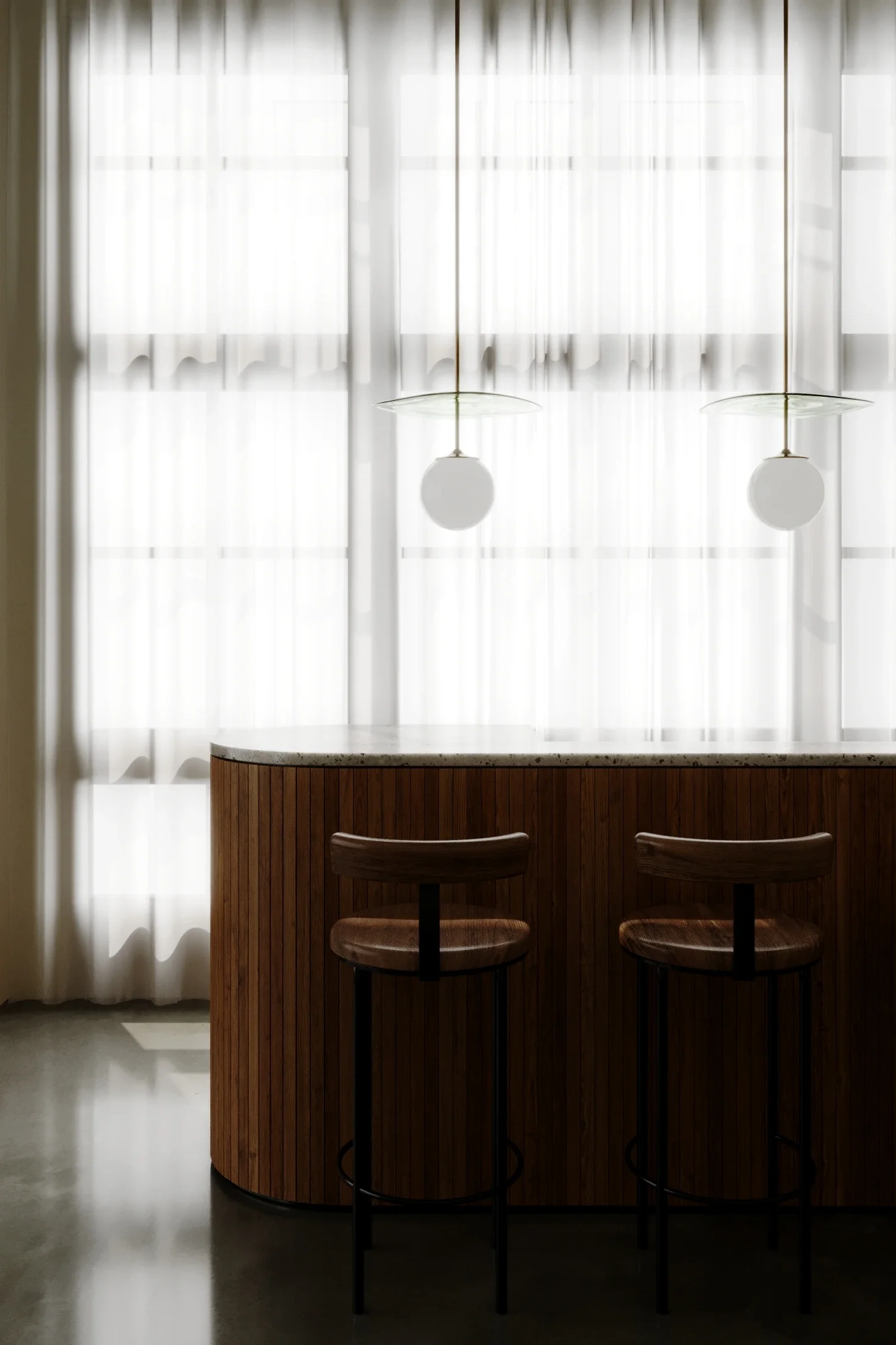 Interior scene with two brown chairs at a wooden bar, large window with sheer white curtains, and two hanging light fixtures