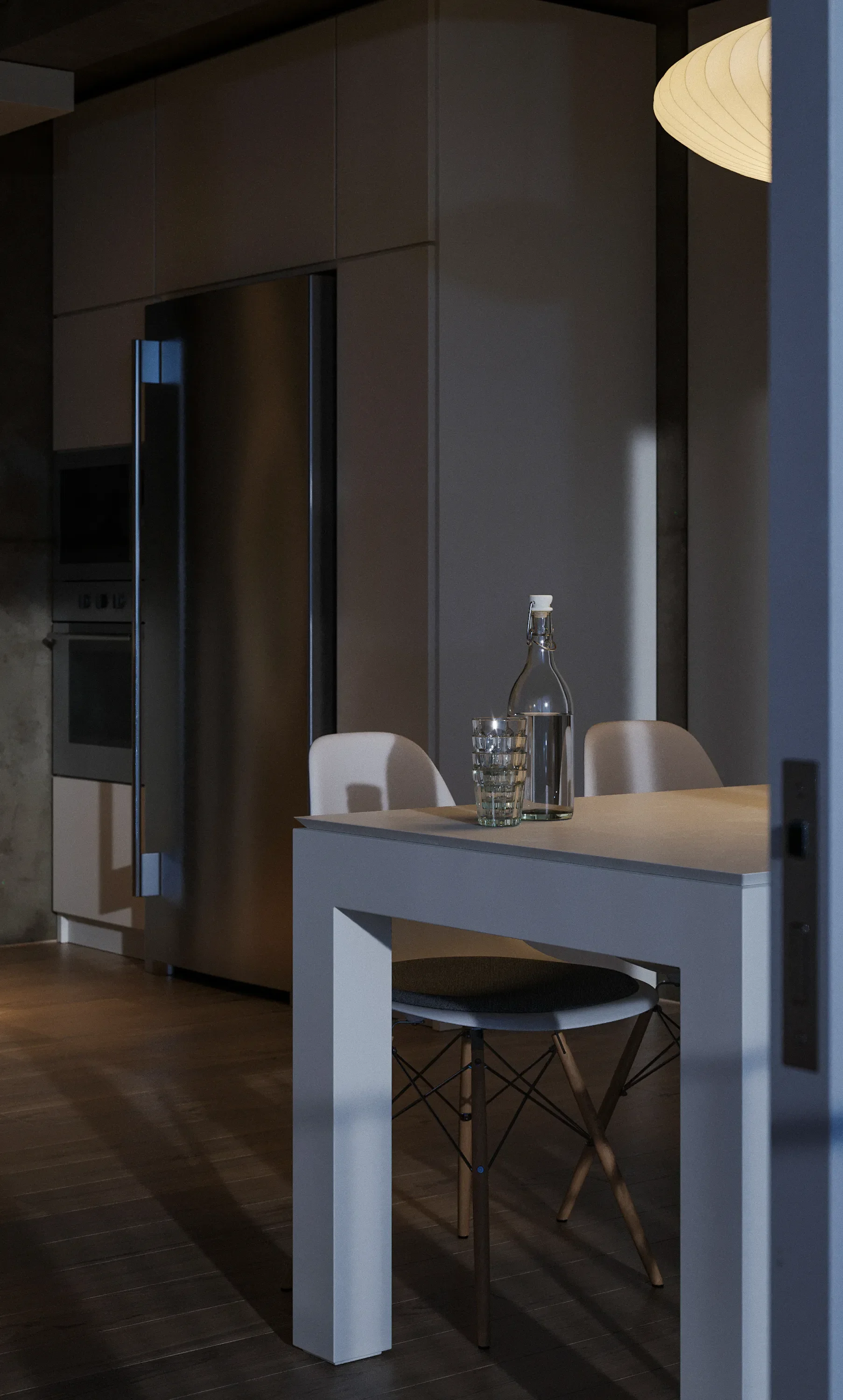 A modern kitchen with a wooden dining table. On the table are a glass carafe, a glass, and a glass with water. Two white chairs are positioned around the table, and a large pendant light hangs above. In the background, there is a built-in appliance a