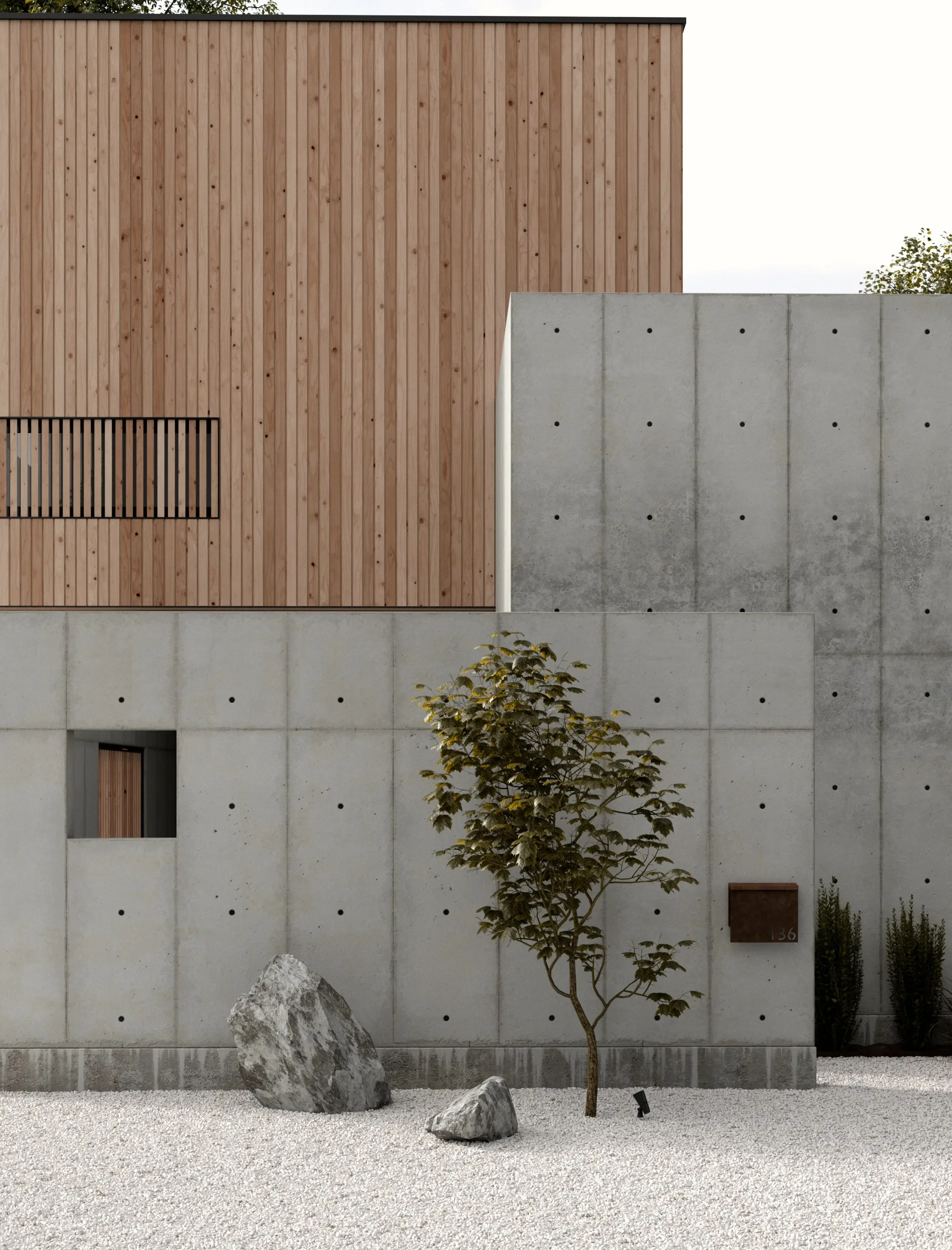Modern building facade with wooden upper section and concrete lower section, small tree, rocks, and gravel ground.