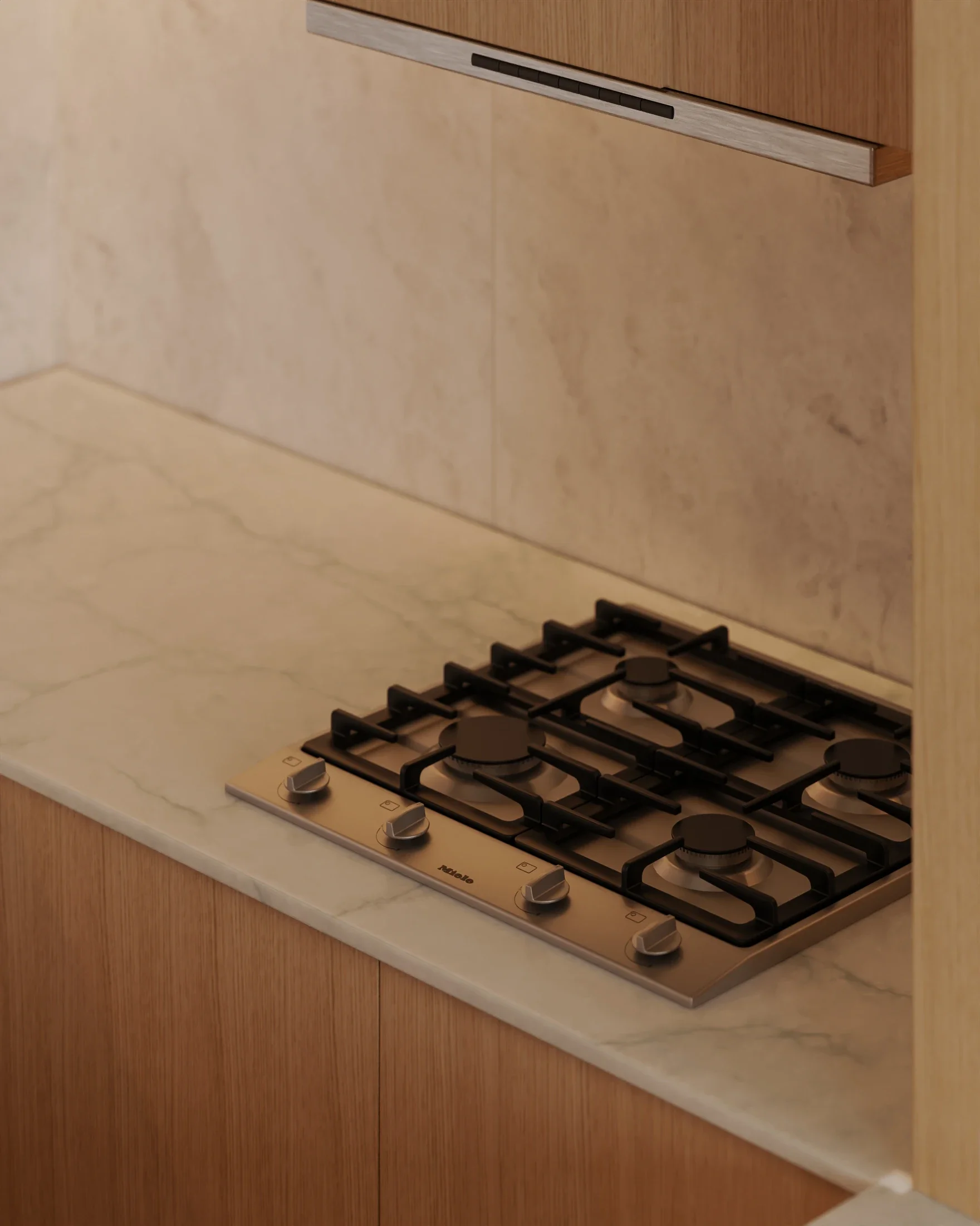 Stovetop with three burners and control knobs on a marble countertop in a kitchen.