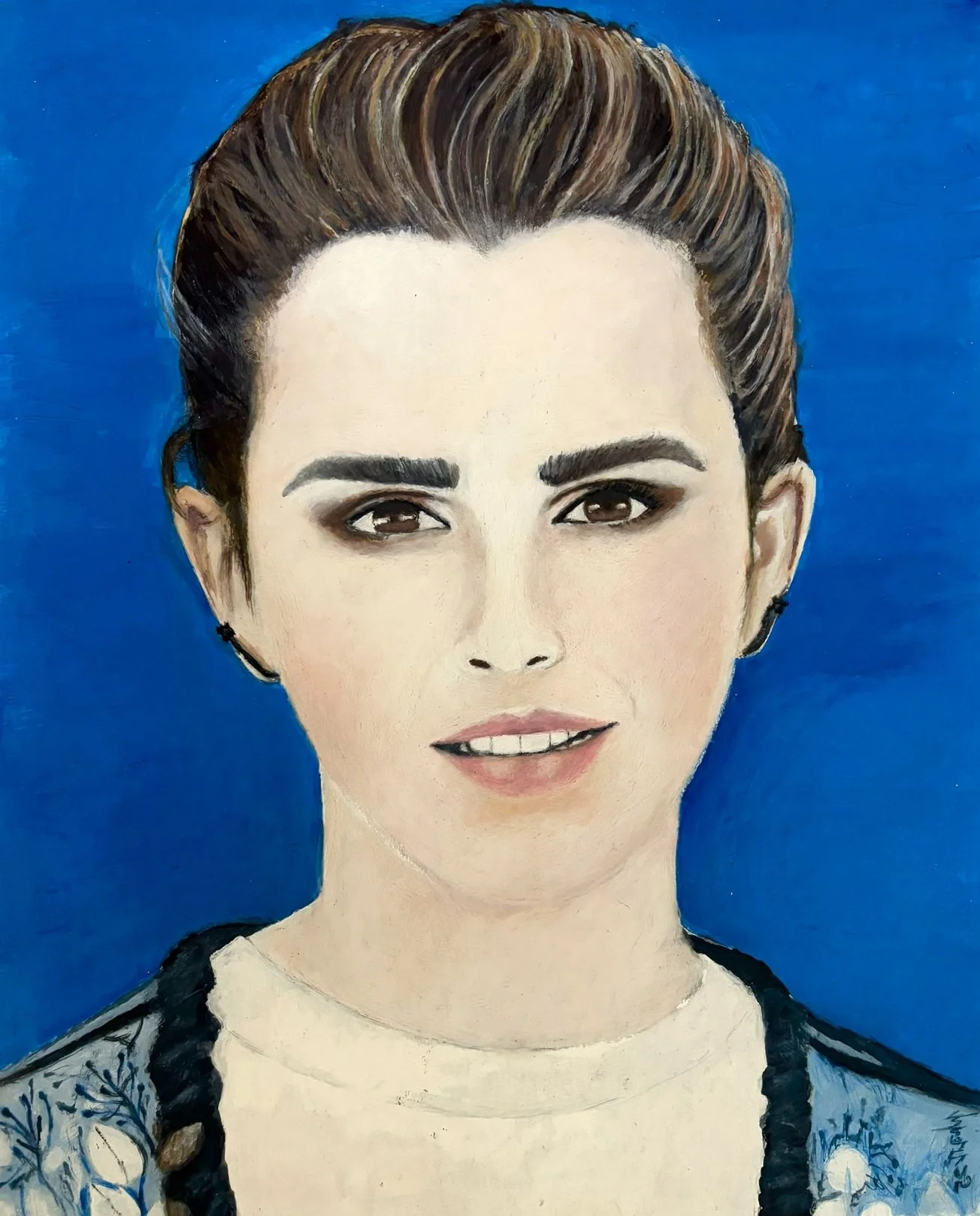 "Emma Watson" / 2025 / Acrylic paint on Bristol / 17" x 14" / FOR SALE $500-1000. A realistic color portrait of Emma Watson on a blue background. Emma has short brown hair and is wearing a light blue floral cardigan