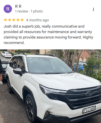 A white Subaru SUV parked in a driveway, with a 5-star review praising Josh’s ceramic coating Wollongong service and support.