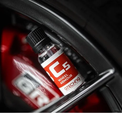 Bottle of Gtechniq C5 Wheel Armour with red car brake caliper in background