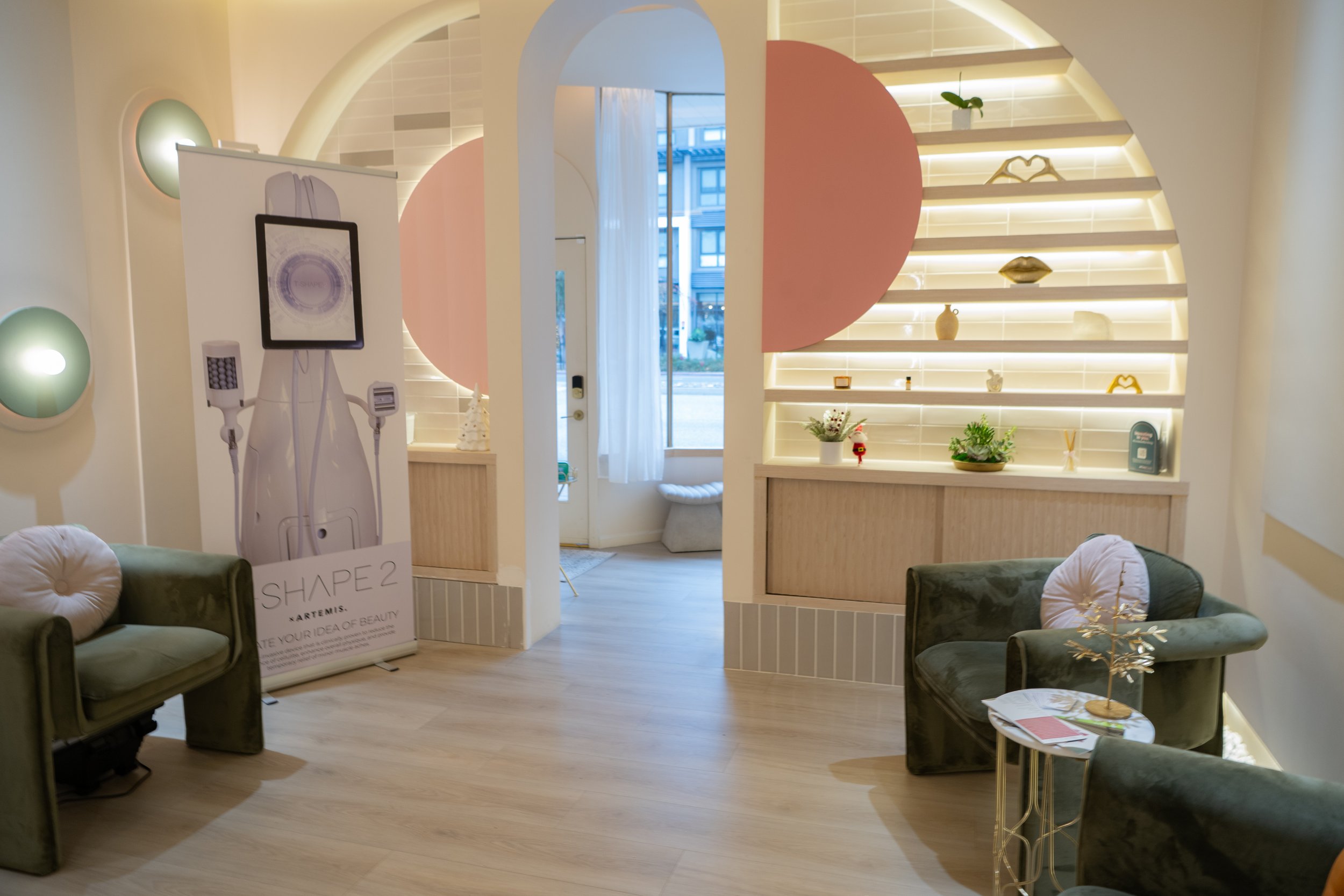 FR Medical Spa waiting area with a T-Shape 2 device banner next to green velvet lounge chairs