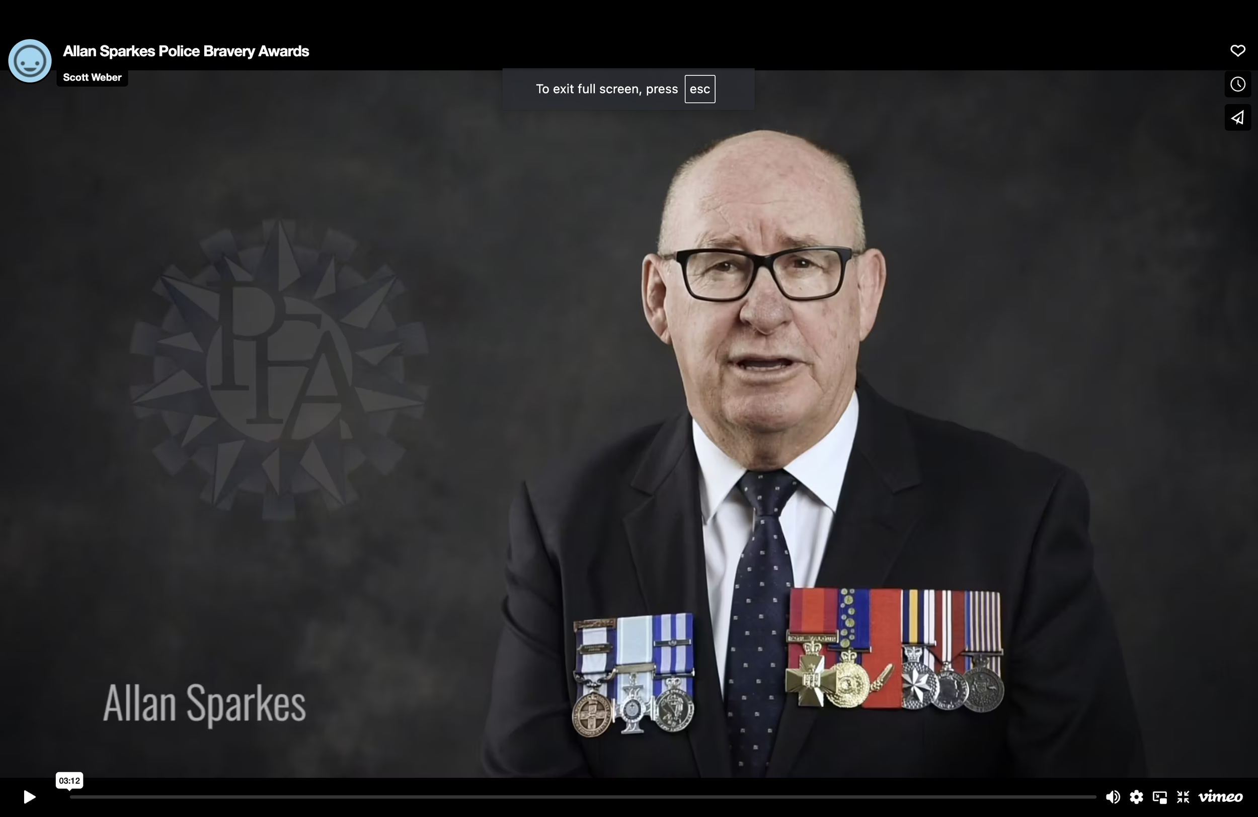 Portrait of Allan Sparkes wearing a suit and tie, with numerous medals pinned to his jacket, at the Allan Sparkes Police Bravery Awards.