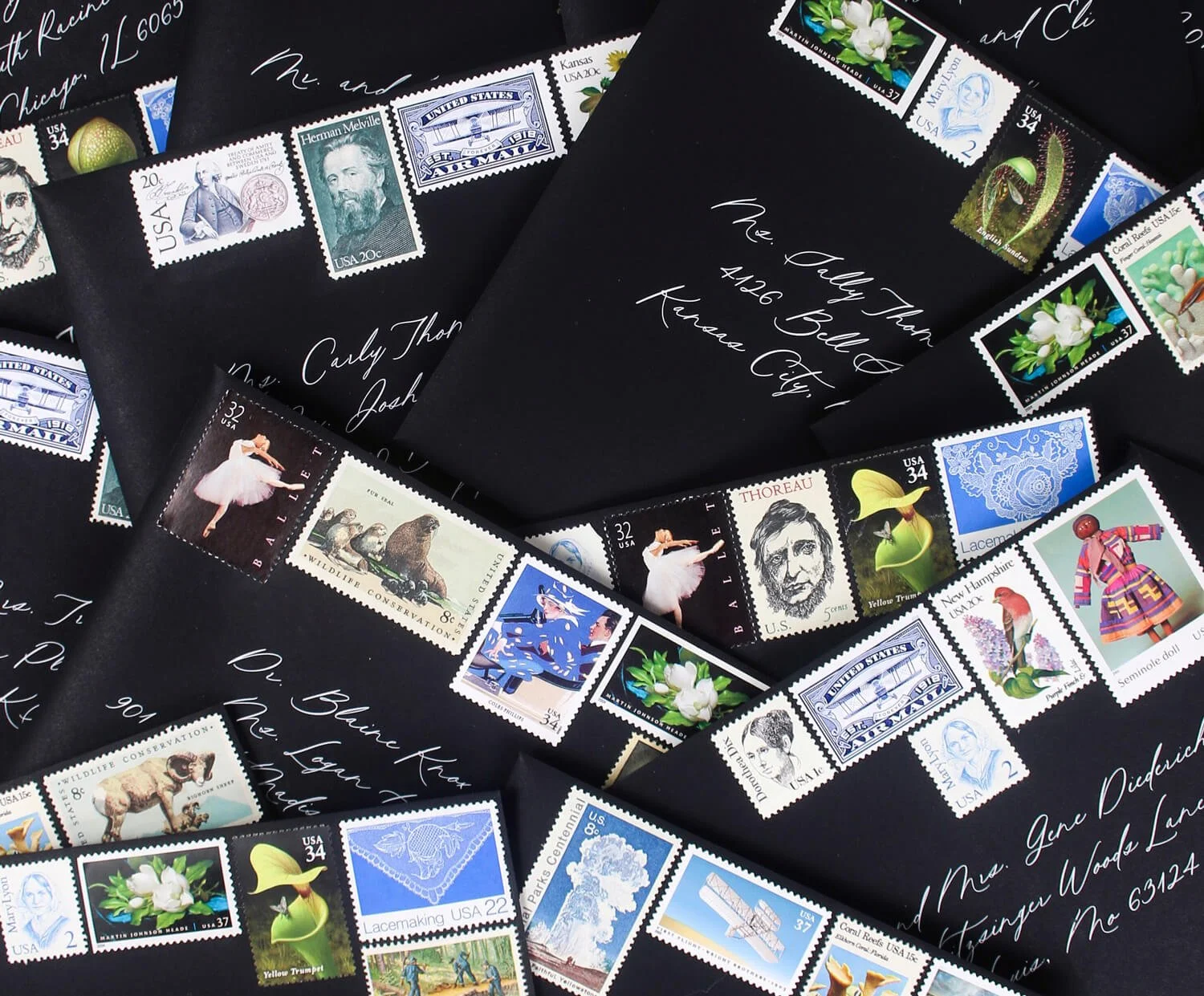 stack of wedding invitation envelopes with vintage stamps