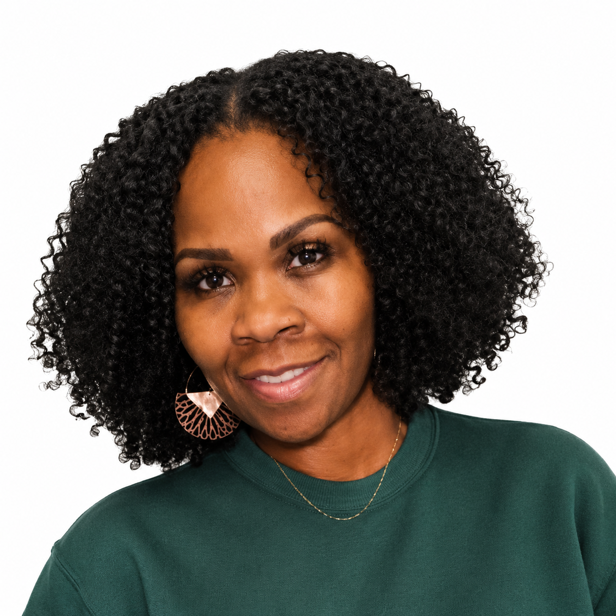 A woman with curly black hair smiling at the camera.