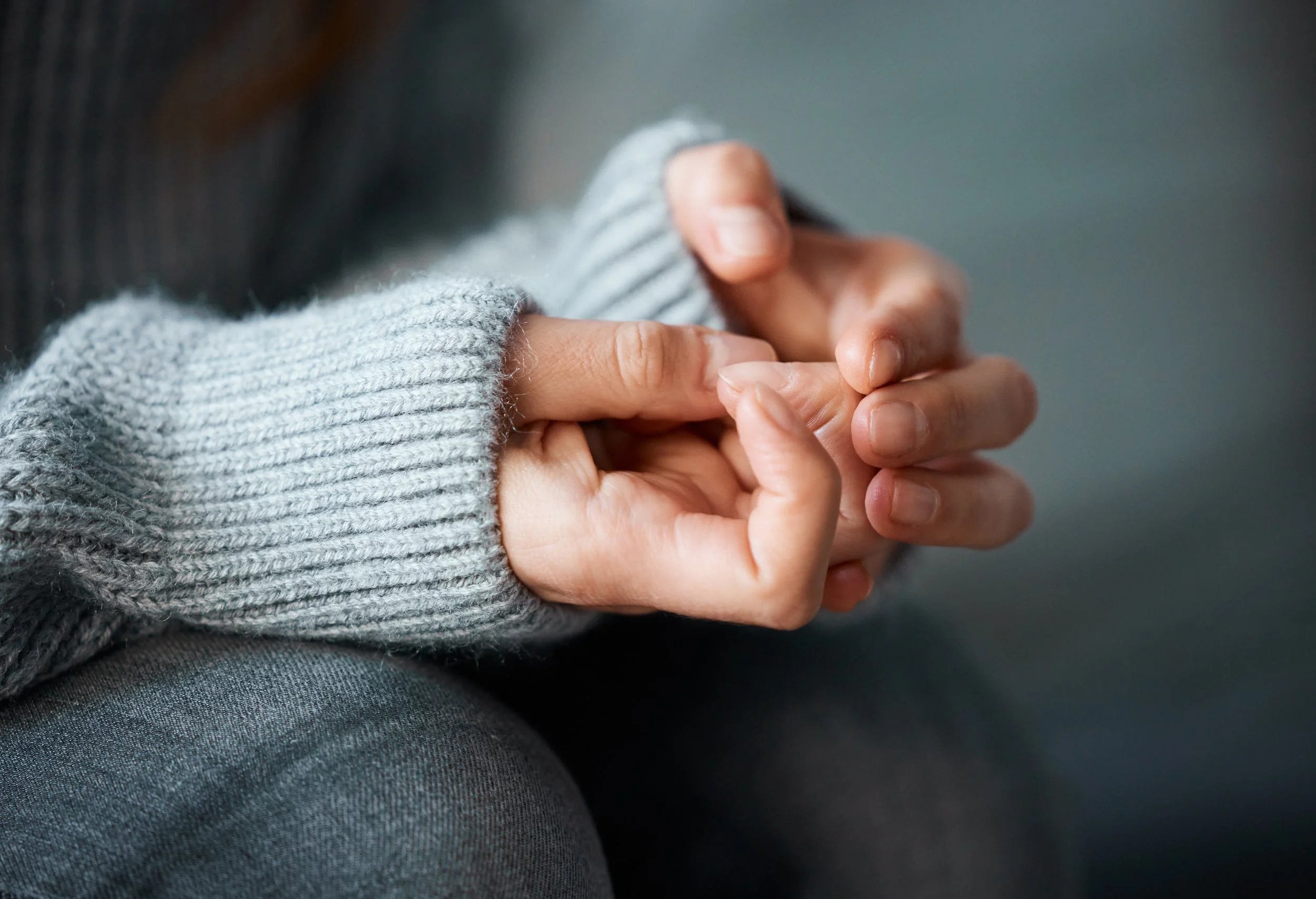 Close up of hands anxiously wringing
