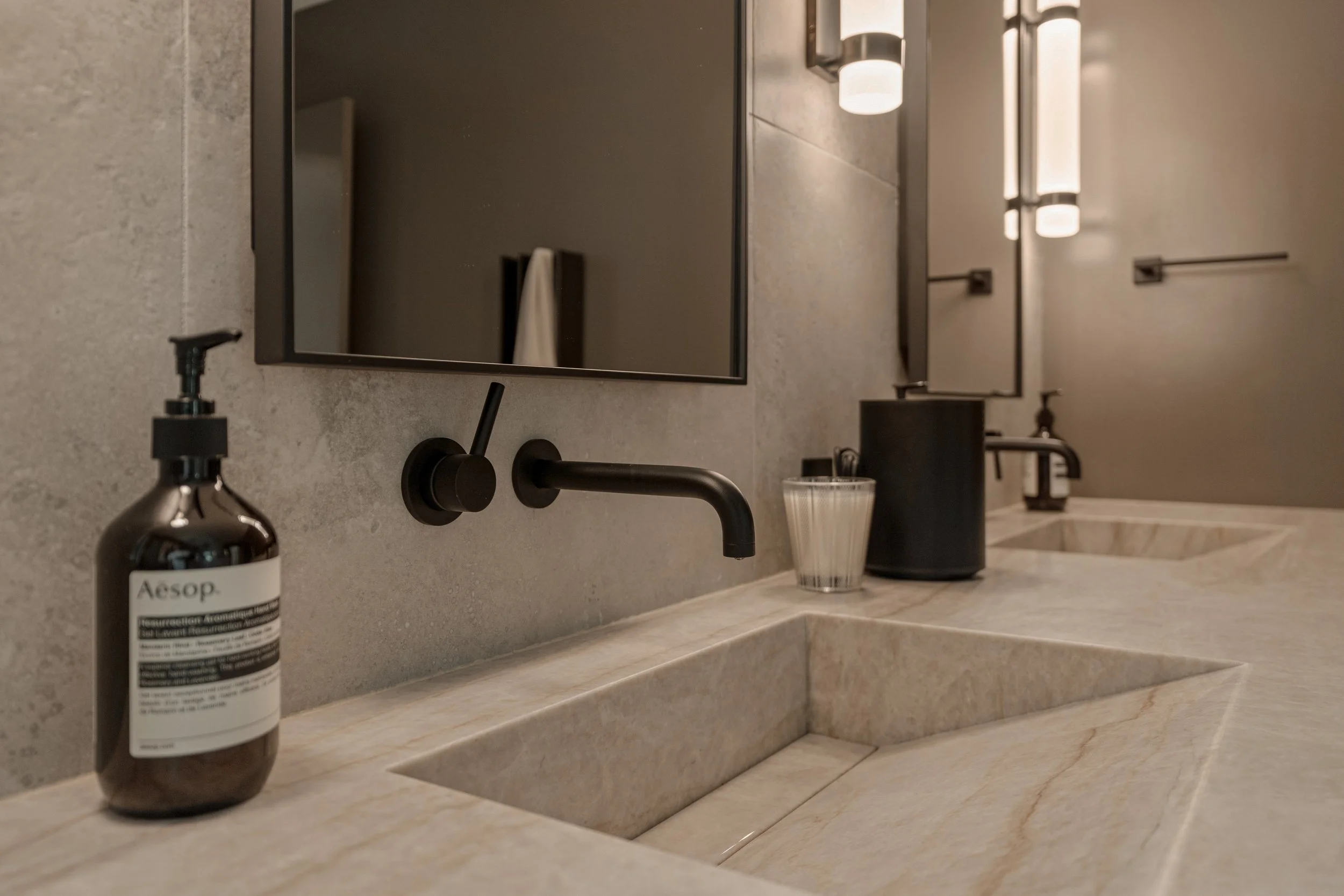 A closer view of the two integrated sinks, clean stone lines, and contemporary design aesthetic.