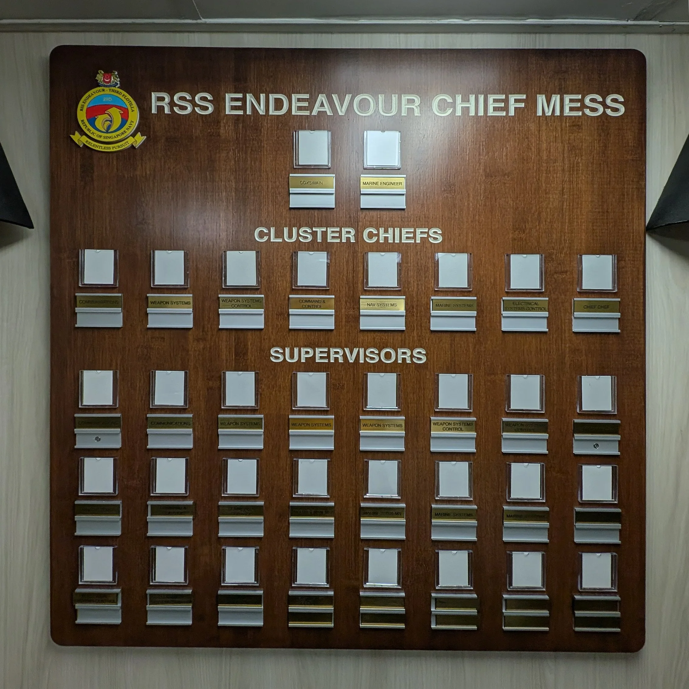Custom wooden recognition board with woodgrain finish, engraved headings, interchangeable nameplates, and military insignia for RSS Endeavour.