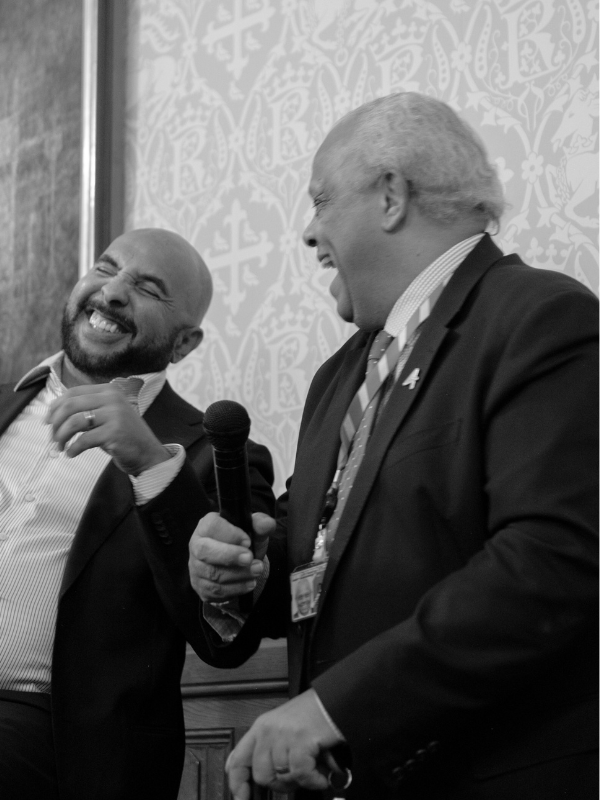 Black and white photo of JUMP's Ken Oliver and Lord Dr Michael Hastings of Scarisbrick CBE speaking at a parliamentary reception at the 2024 W&J Summit in London.