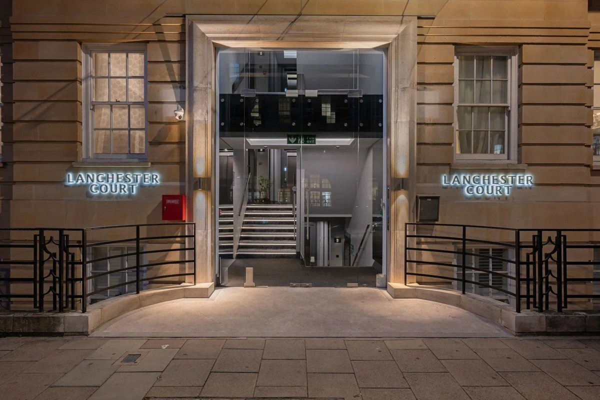 Luxurious open-plan kitchen and living area with ocean view, featuring modern furniture, large windows, and sleek design elements.