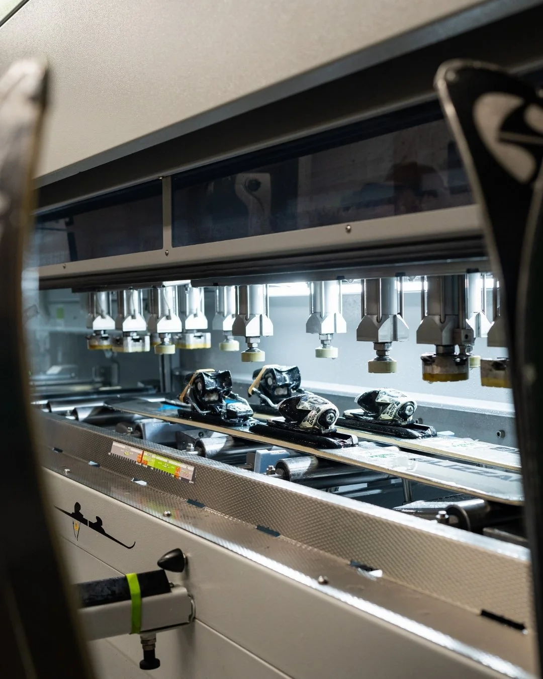 Powder House ski rentals being tuned by the Wintersteiger Jupiter Tuning Machine in Salt Lake City, Utah