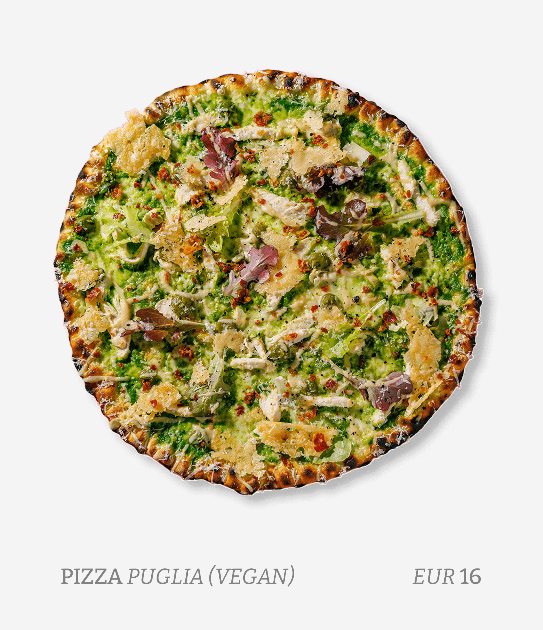 Vegan pizza with green sauce, lettuce, and cheese, topped with herbs and spices, on a white background.