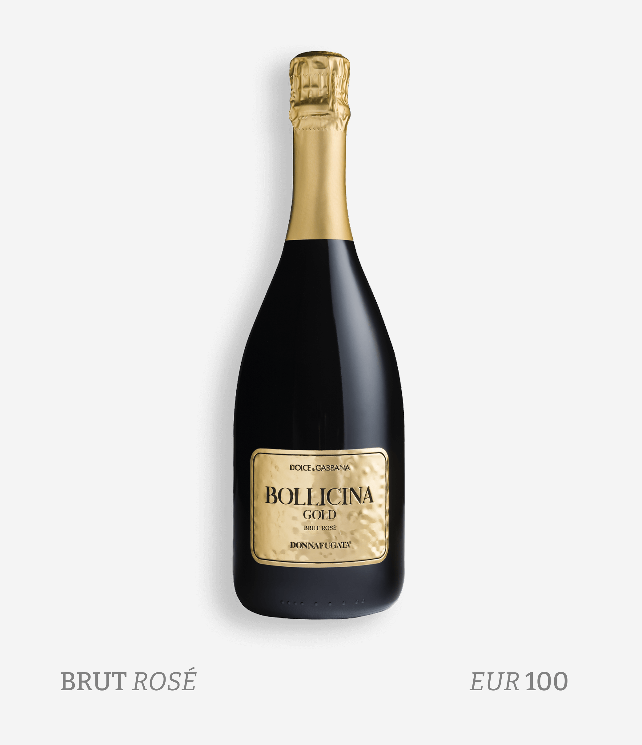 A bottle of Dolce & Gabbana Bollicina Gold Brut Rosé sparkling wine with a black body and gold foil on the neck, set against a white background with text indicating it is a brut rosé priced at 100 euros.