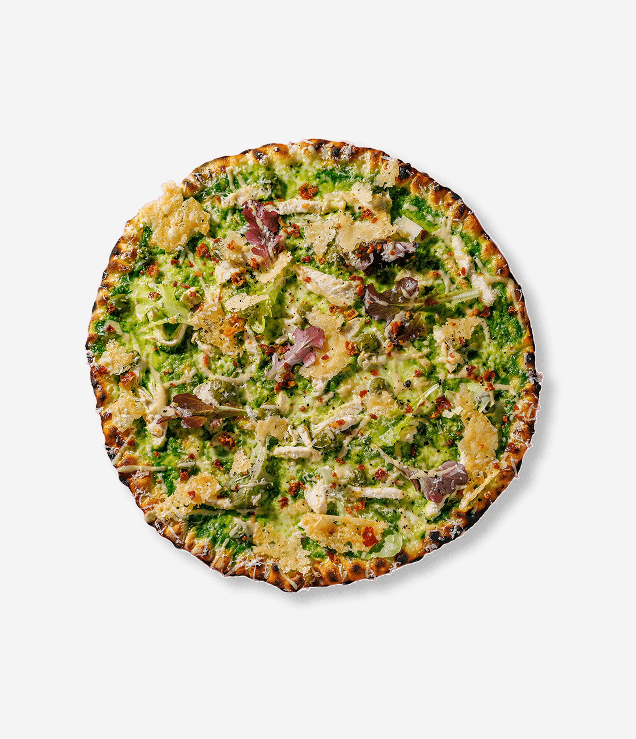 A green vegetable pizza topped with cheese, red pepper flakes, and shredded chicken on a white background.