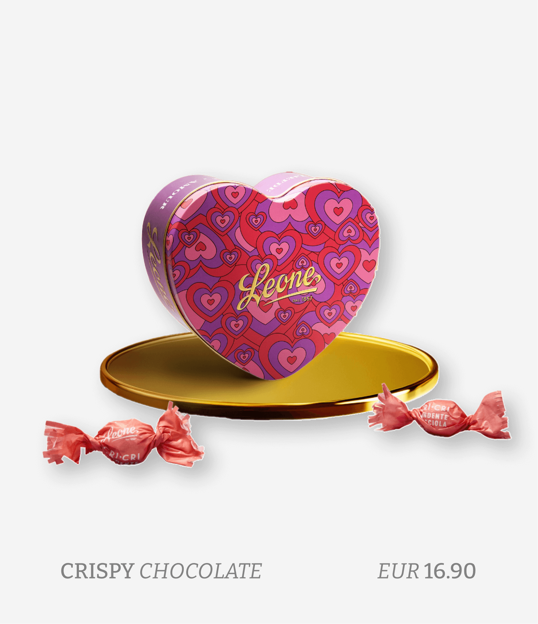 A heart-shaped box of Leone crispy chocolate candies on a gold tray, with two wrapped candies in pink wrappers nearby, against a white background, with text indicating the product is crispy chocolate costs EUR 16.90.