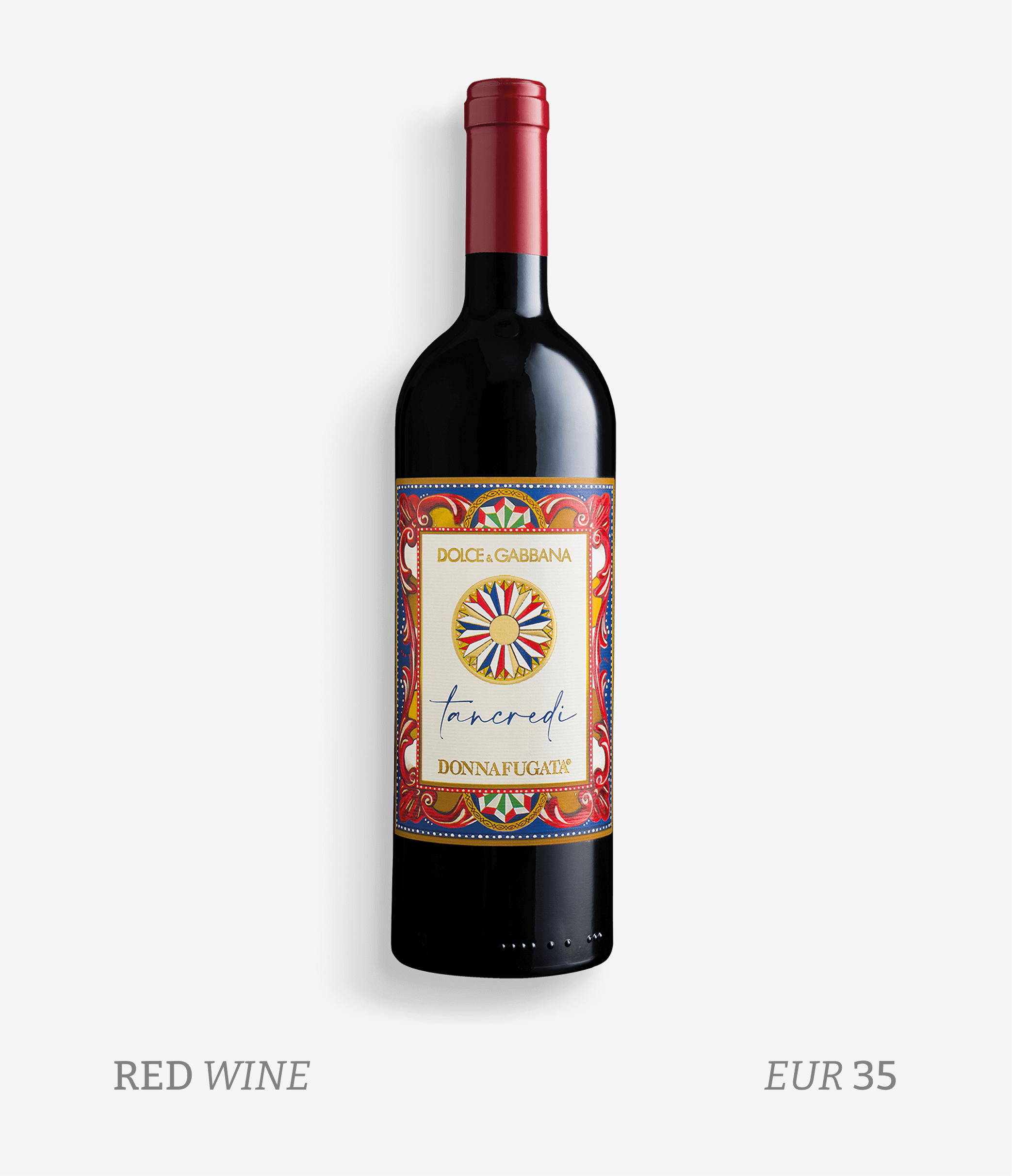 A bottle of red wine with a colorful label that has intricate patterns and the text "Dolce & Gabbana" and "Tancredi". The bottle is set against a plain background. Below the bottle, the text reads "Red Wine" and "EUR 35".