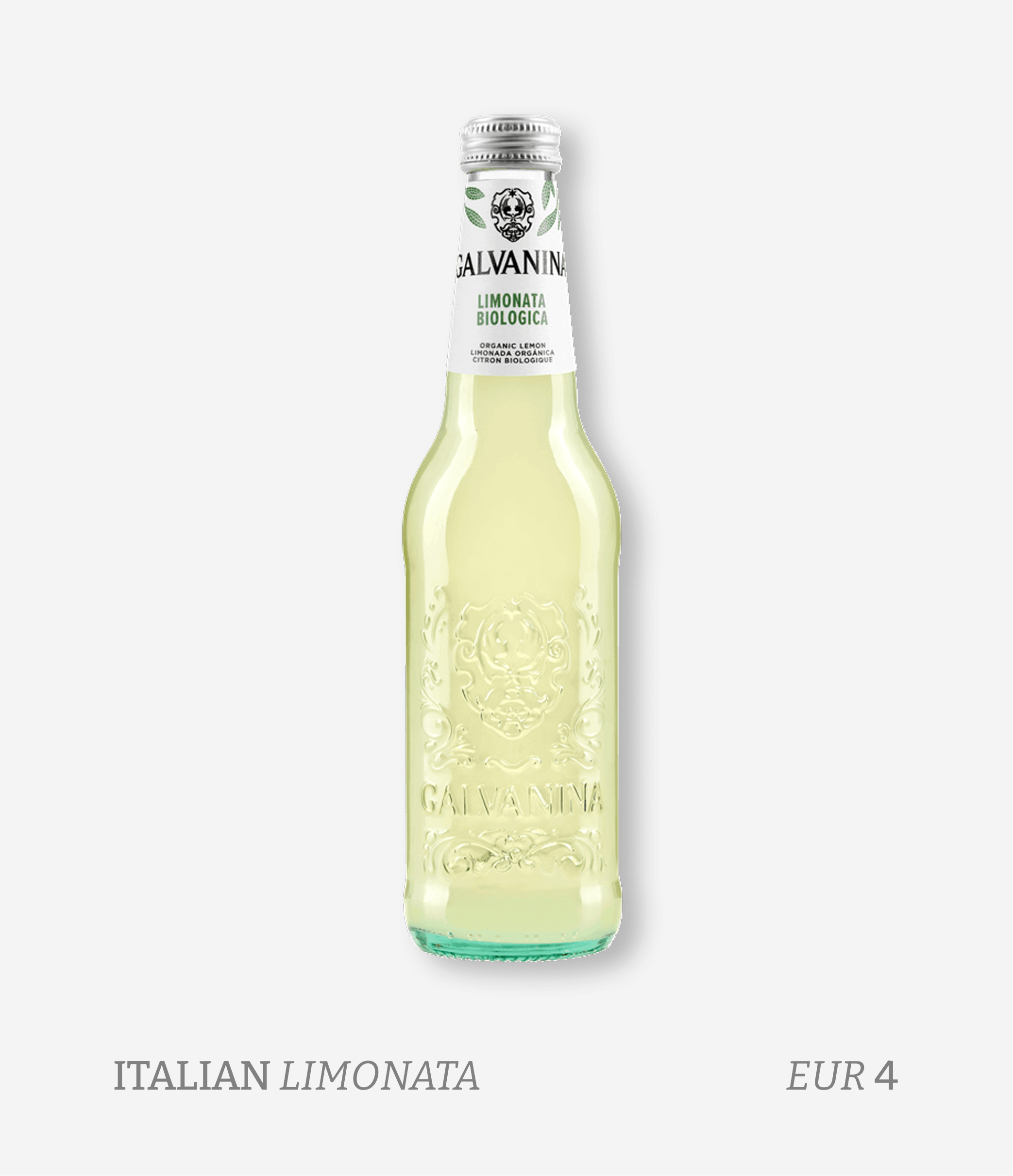 A clear glass bottle of organic lemon-flavored soda with embossed design and a white label at the neck, featuring green leaves, a black ornate logo, and text indicating it is a biological lemon soda from Italy priced at 4 euros.